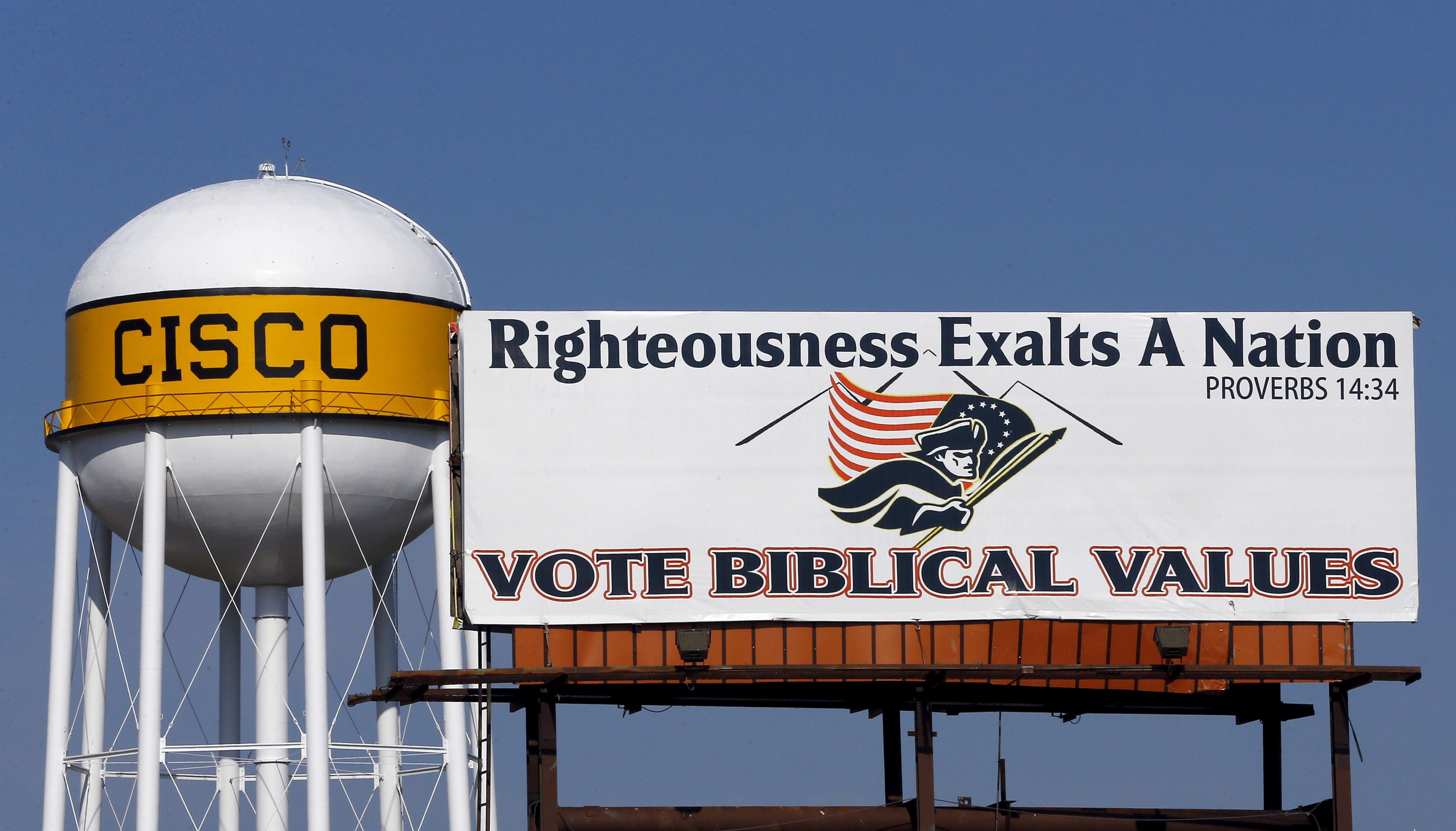 A billboard urging consideration of biblical values when voting is displayed in Cisco, Texas, near where Farris Wilks preaches, in August 2015. Photo by 