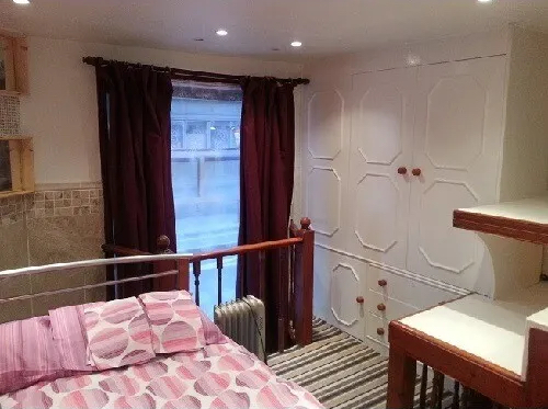 The wardrobe of a mezzanine bedroom of a double mezzanine studio to rent in Vaxuhall, London