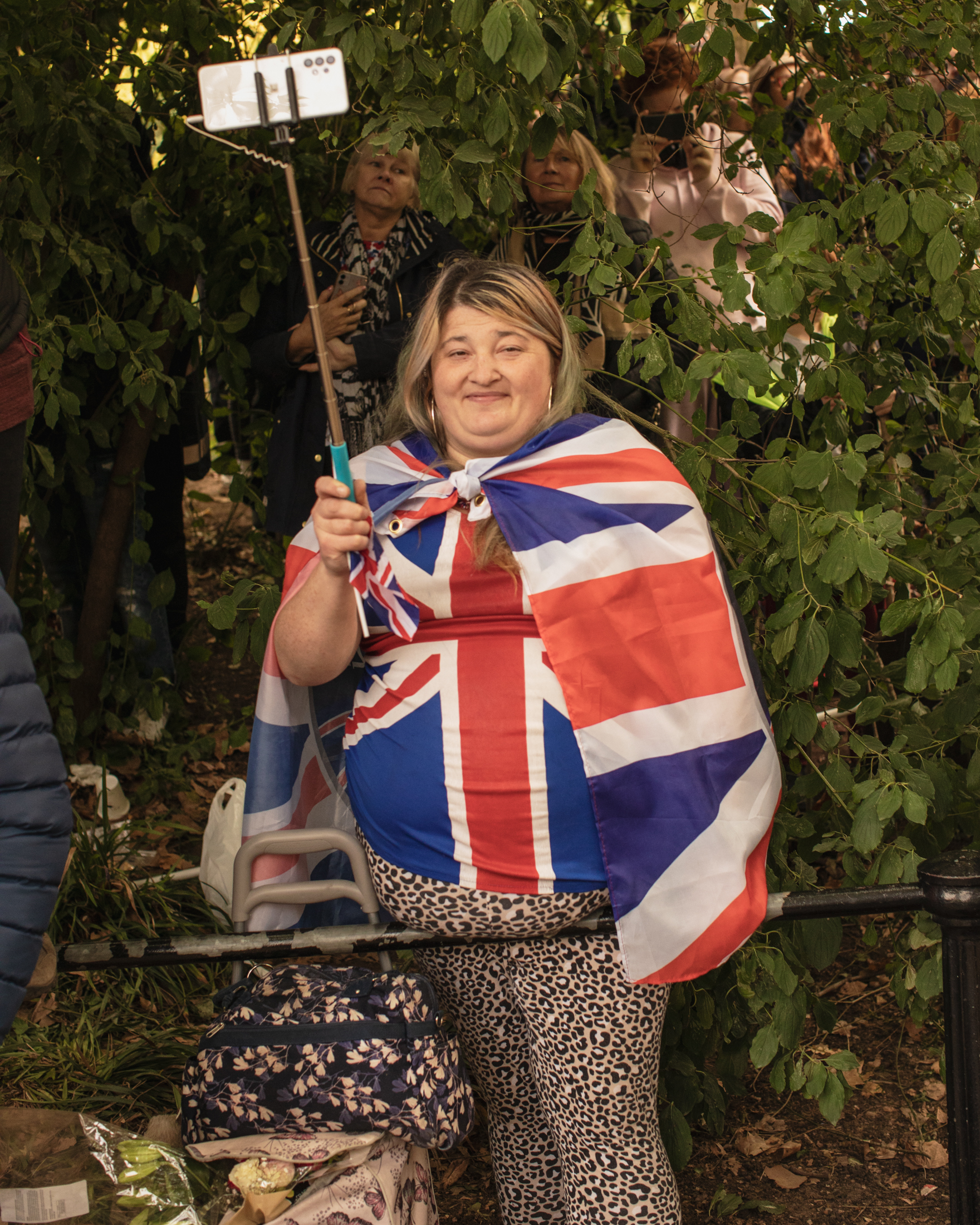 Woman wrapped in Union Jack flag during Queen Elizabeth II's funeral