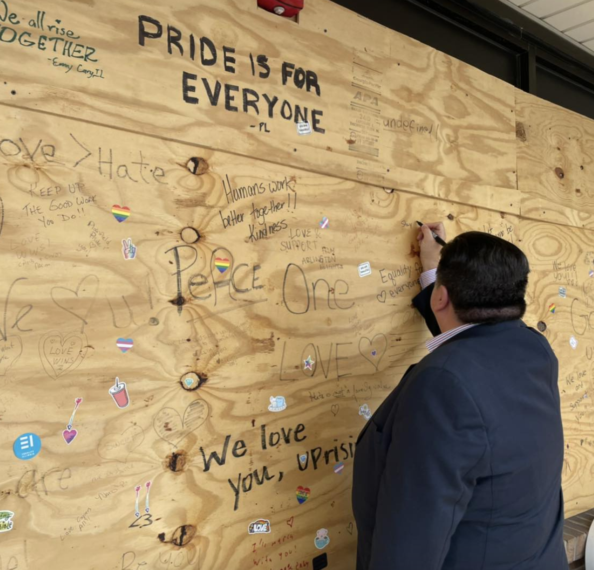 On Aug. 5, 2022, Illinois Gov. J.B. Pritzker visited UpRising Bakery and added his name to a wall containing messages of support. Photo via UpRising Bakery's Facebook page. 