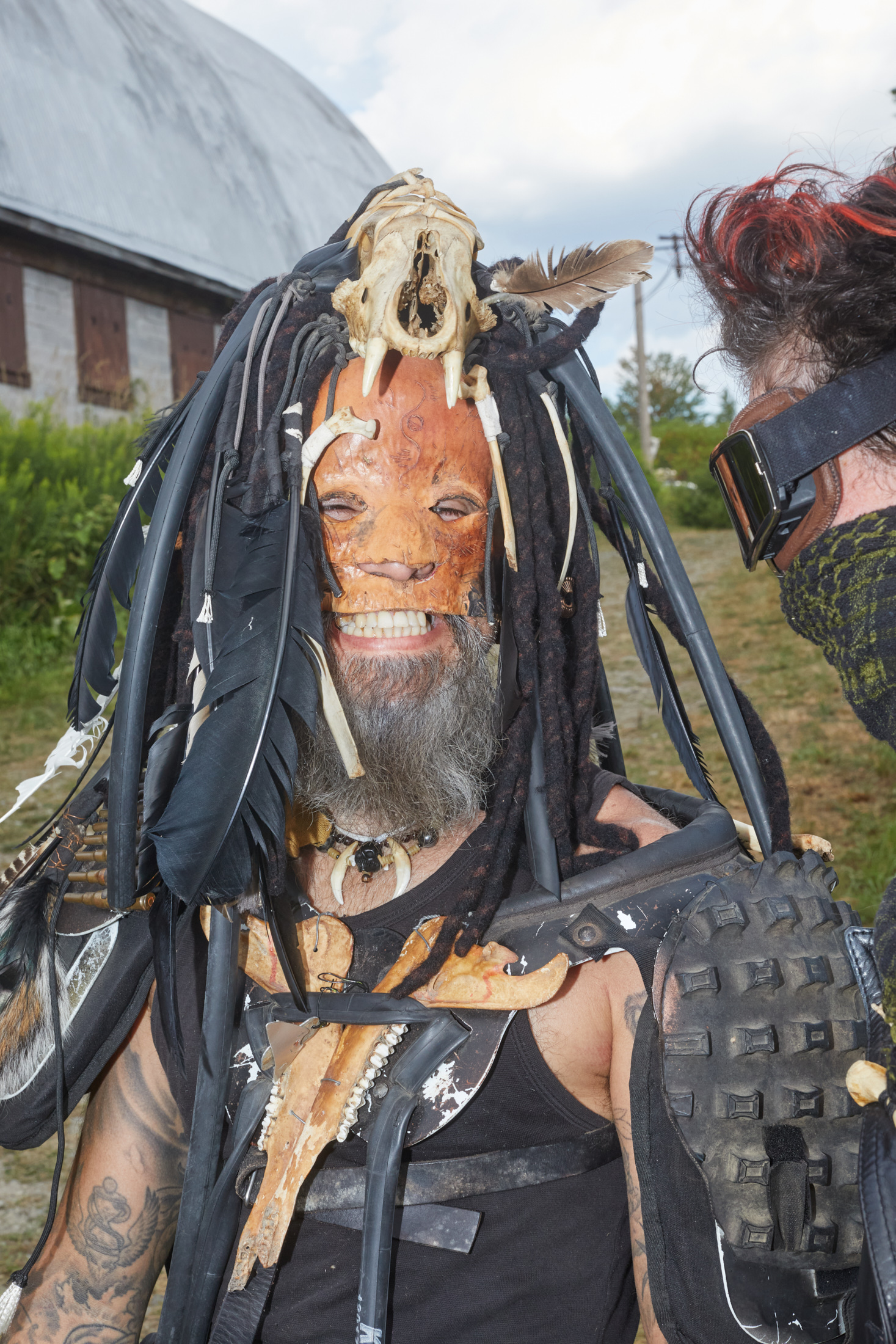 A man in a post-apocalyptic themed costume that includes a leather mask