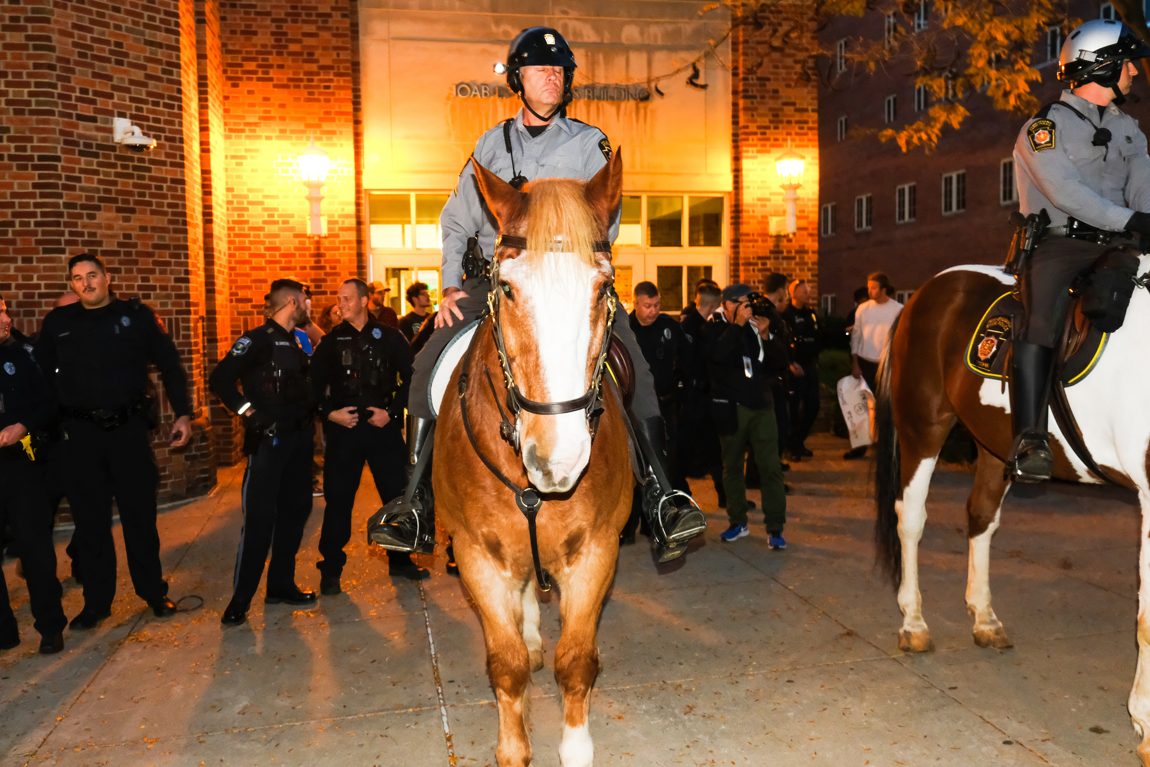 Penn State deployed officers on horseback to control the crowds of student protesters. Photo by Tess Owen