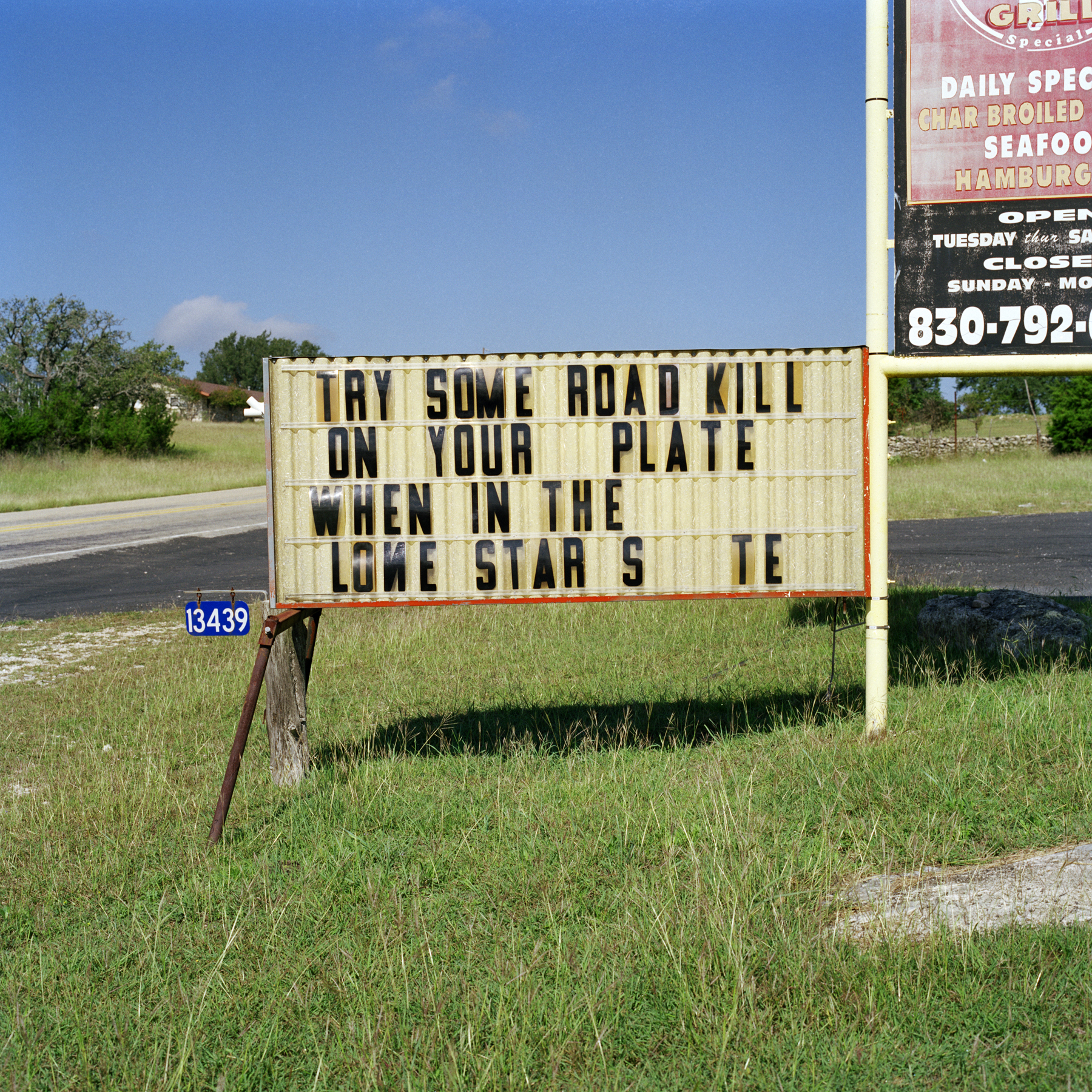 A “Try some roadkill” sign in Texas in the mid-2000s
