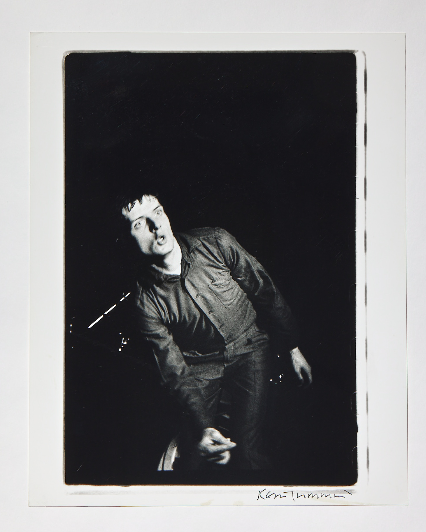 a black and white candid image of ian curtis of joy division on stage by kevin cummins