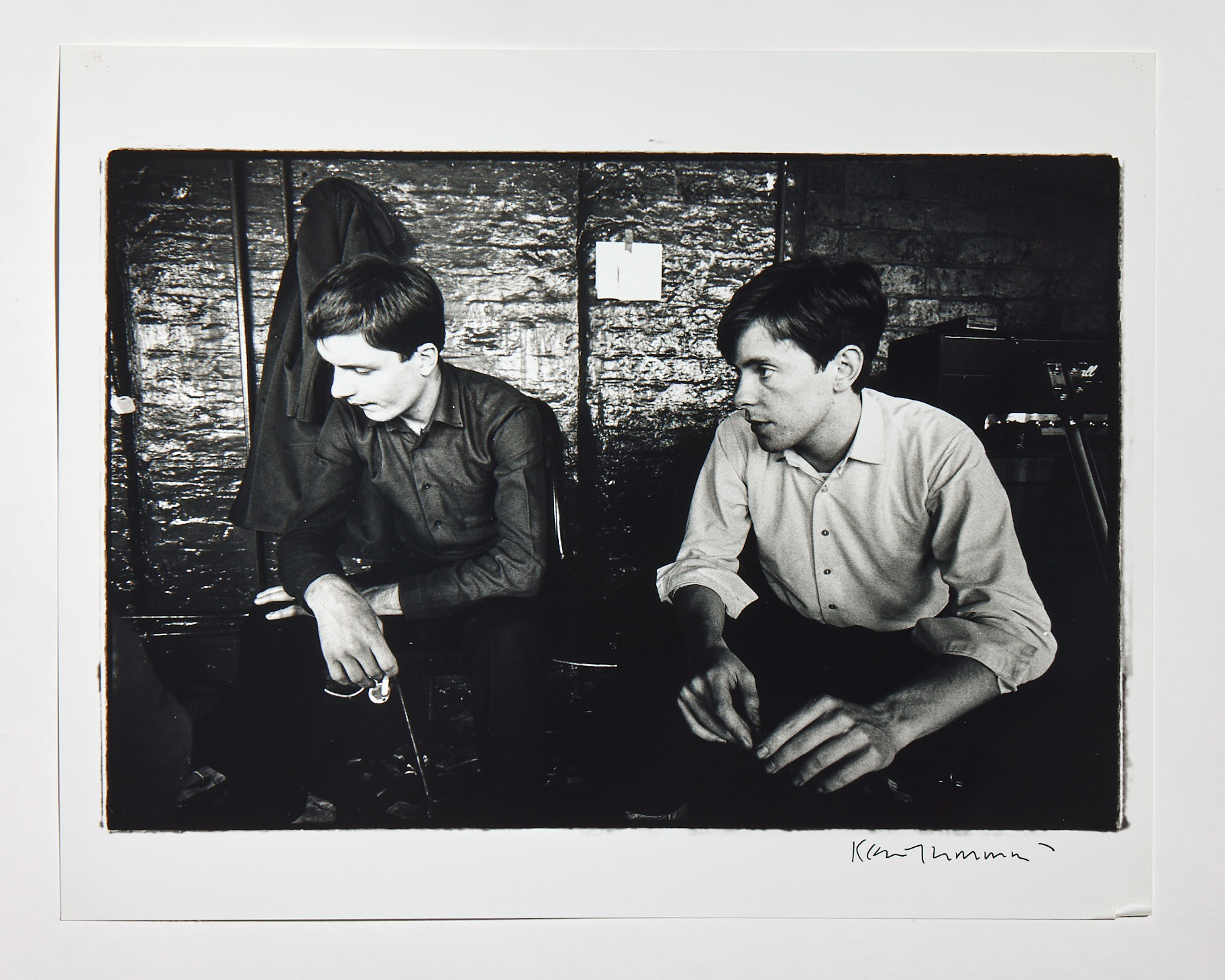 a black and white candid image of ian curtis and stephen morris of joy division by kevin cummins