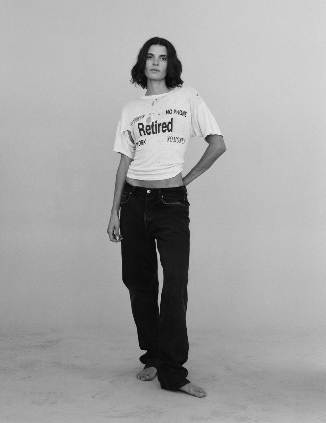 a model wears a vintage T-shirt that reads 
