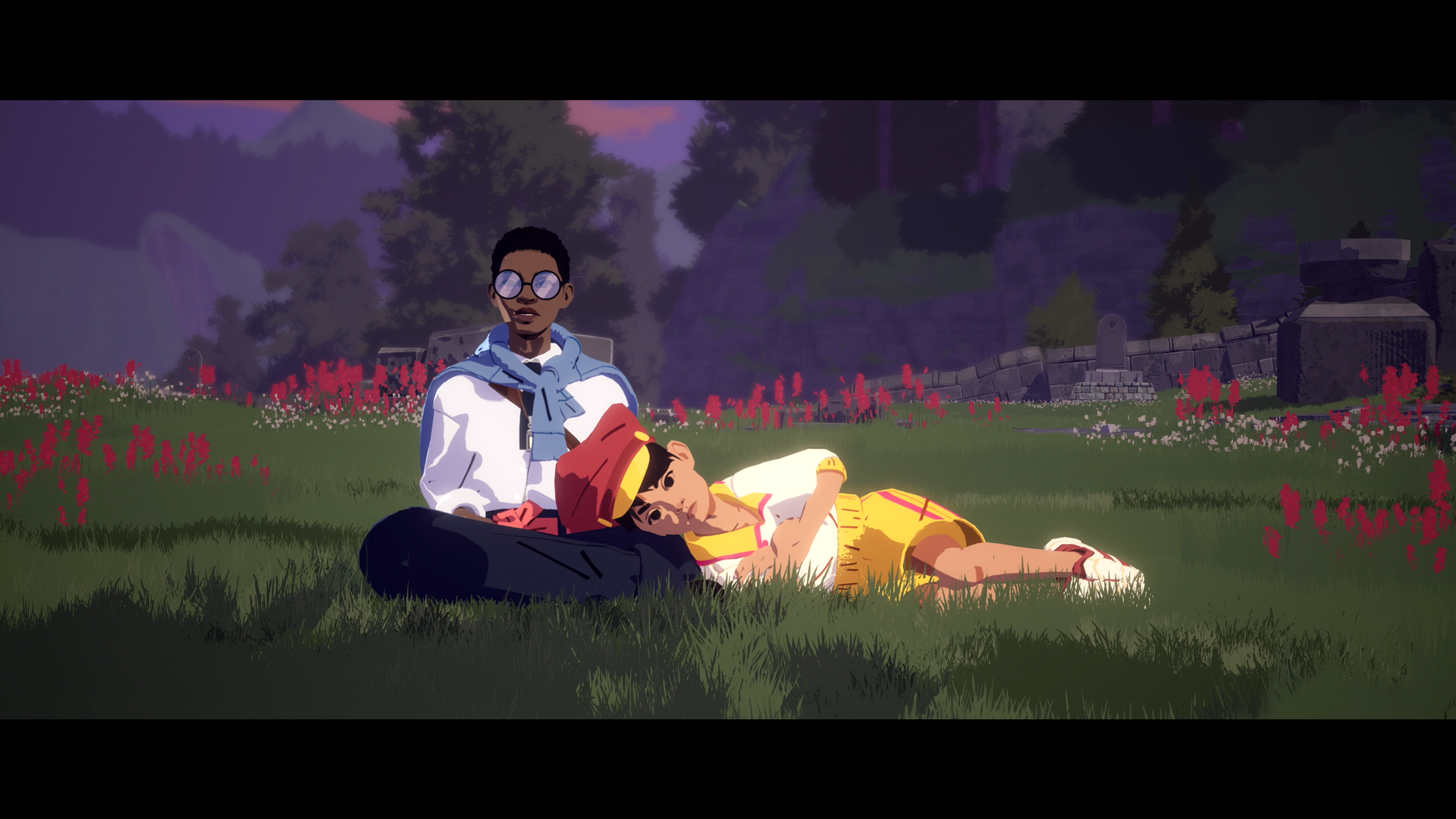 A young boy lays with his head in a woman's lap amid a field of red flowers.