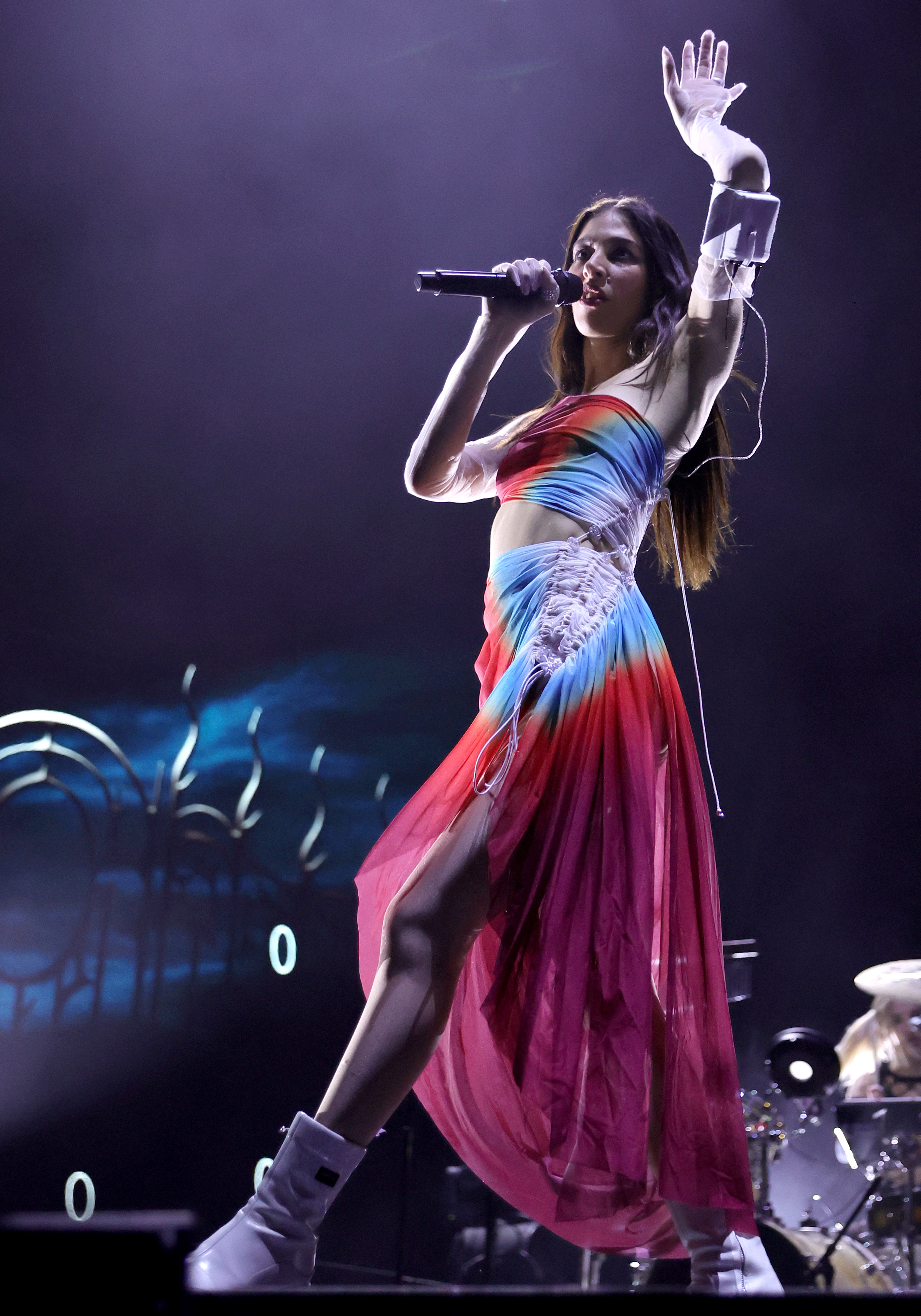 caroline polachek performing in a rouched rainbow dress