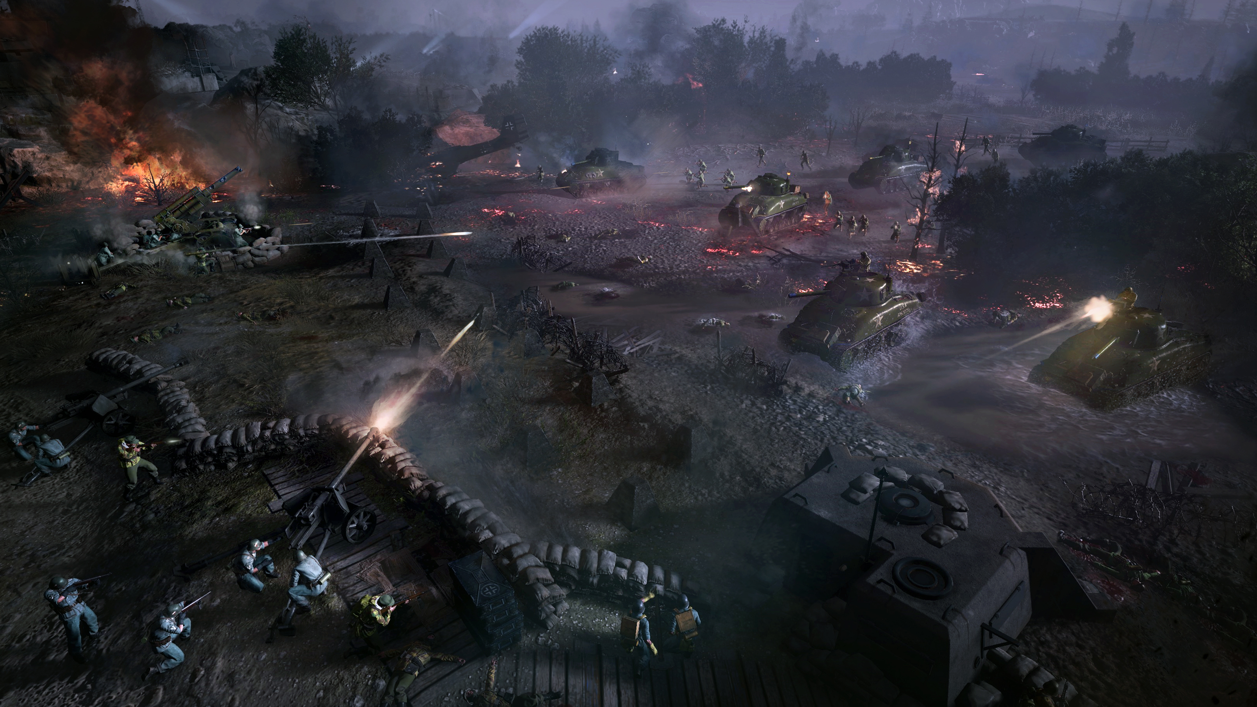 Sherman tanks advance across a darkend battlefield, guns blazing at German troops hunkered behind barricades