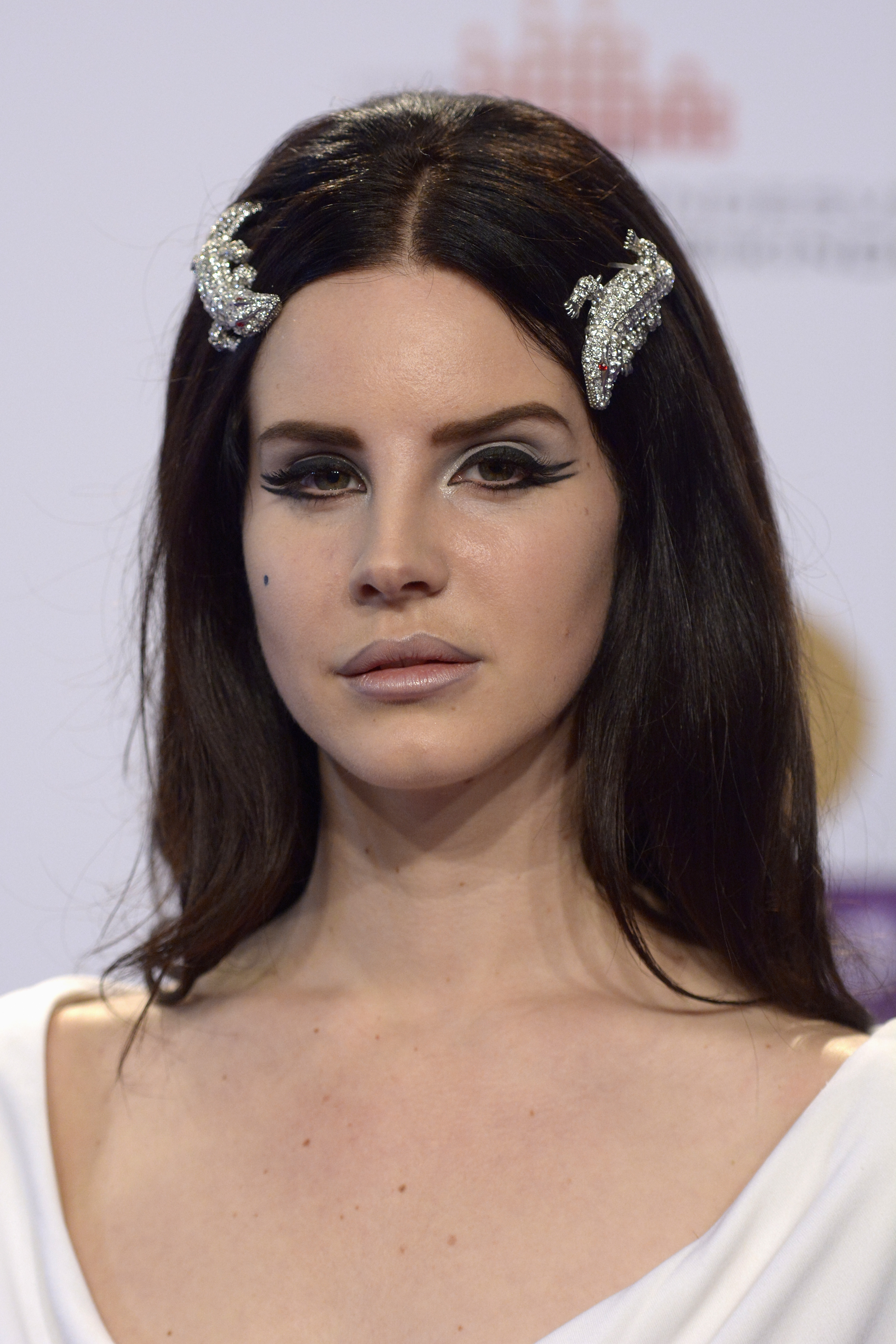 lana del rey with dark hair, diamnond alligator hair clips and double-winged eyeliner