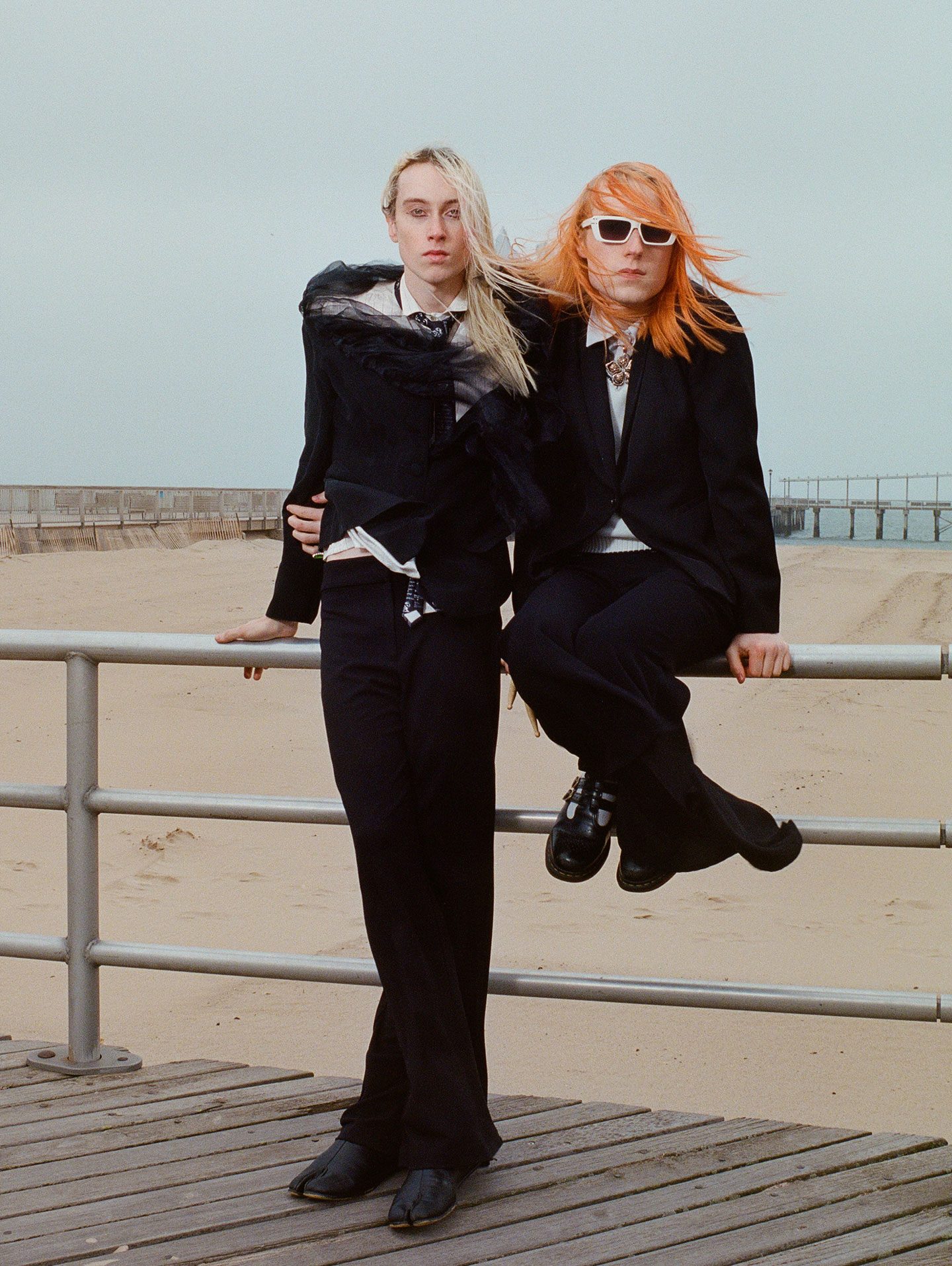 frost children stand on coney island boardwalk, leaning on a railing