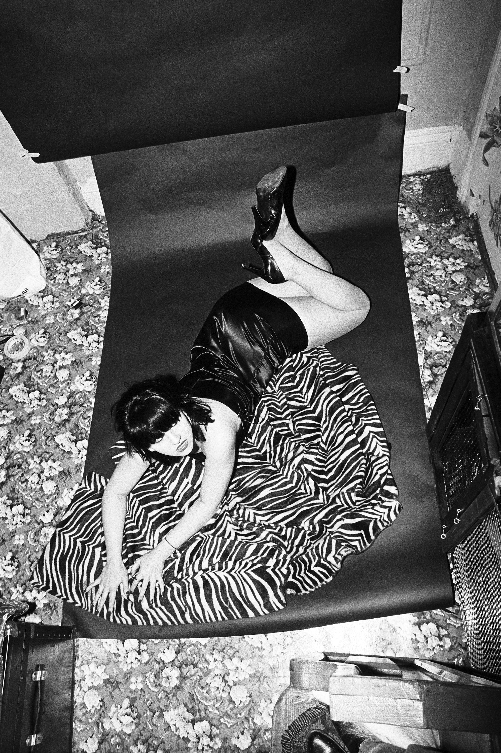 lydia lunch lying on a zebra coat in her east village apartment on the floor