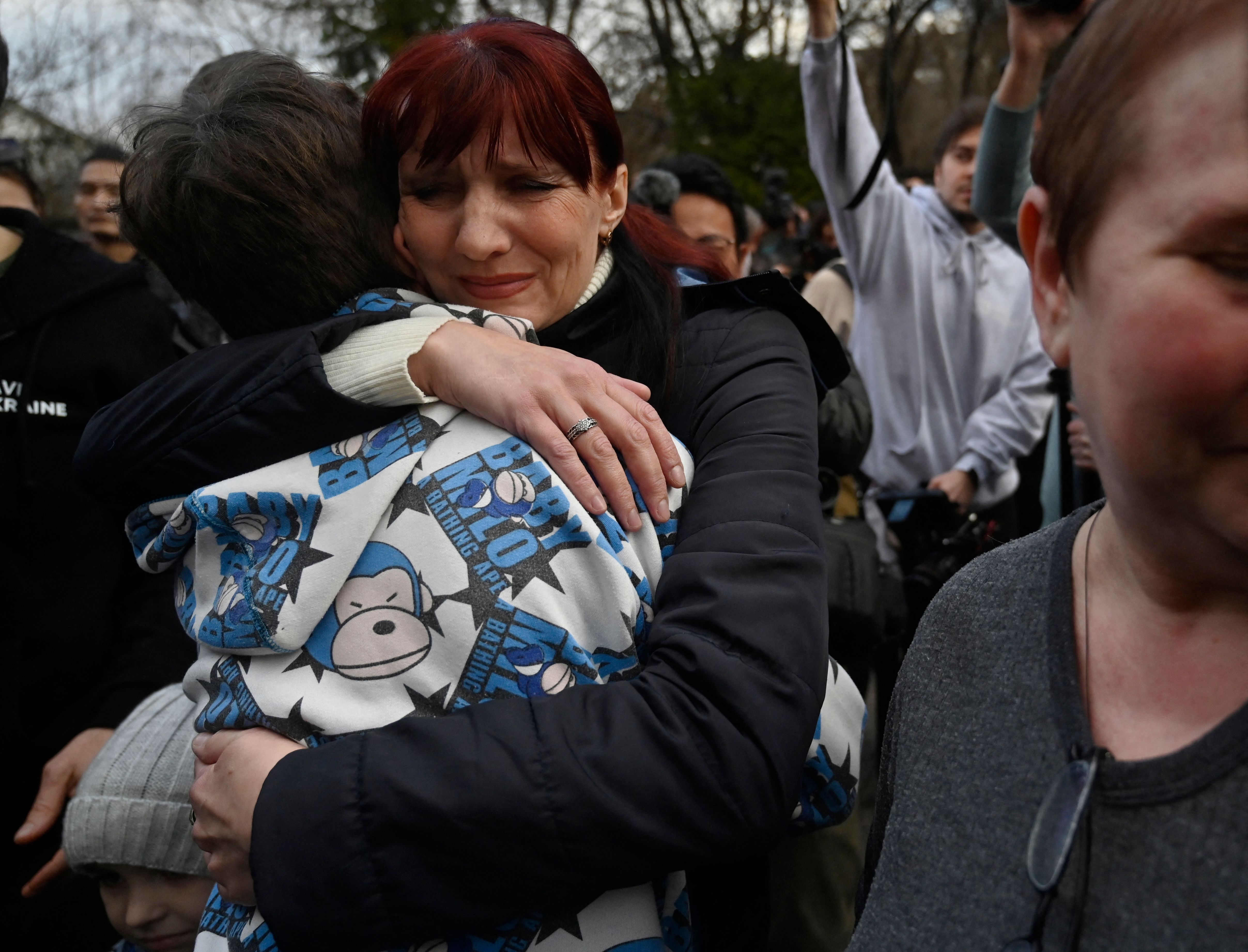 Inessa hugs her son Vitaly after the bus delivering him and more than a dozen other children back from Russian-held territory arrived in Kyiv on March 22, 2023. Photo: SERGEI CHUZAVKOV / AFP via Getty Images