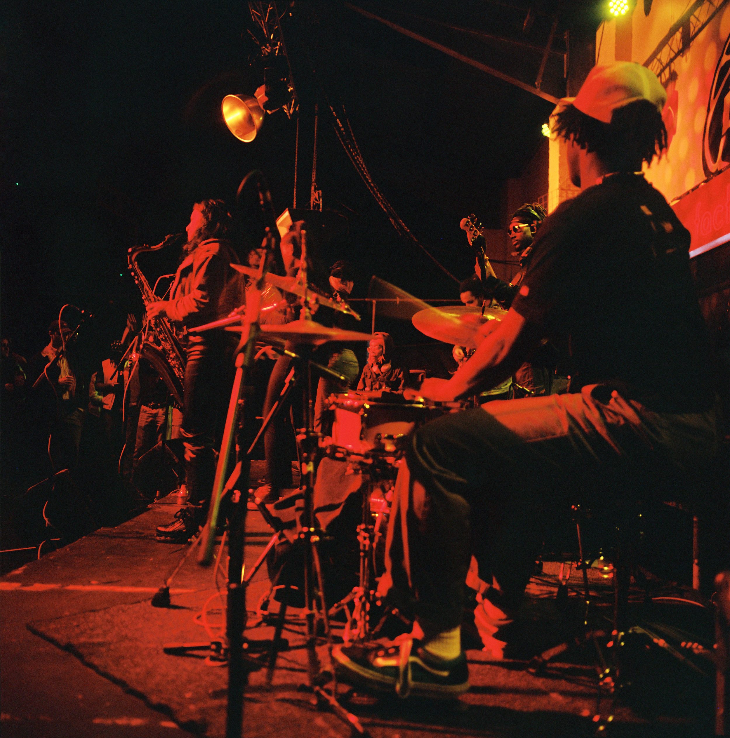a jazz band playing on stage in red light in london