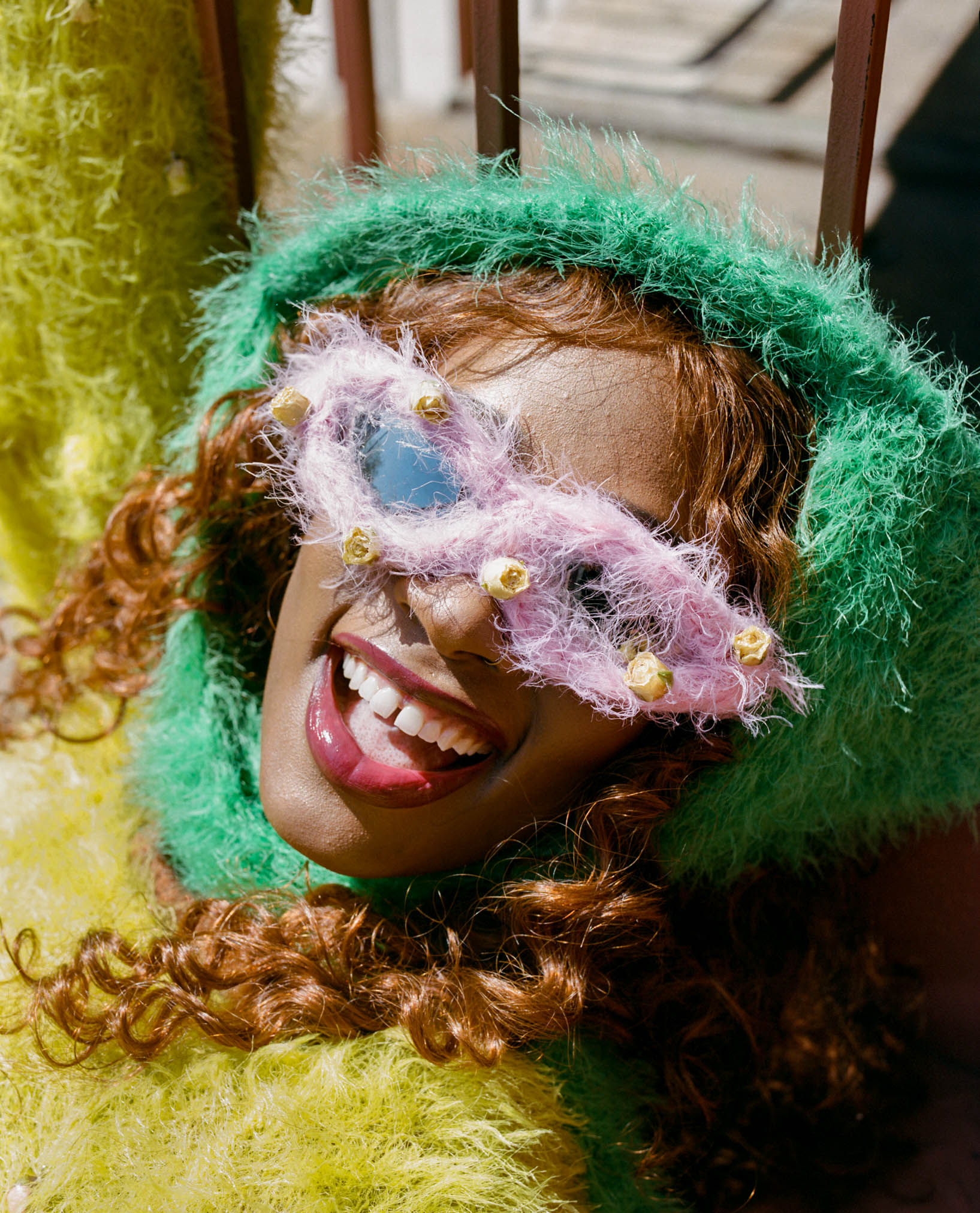 rapper kari faux smiling with her mouth open wearing fuzzy sunglasses