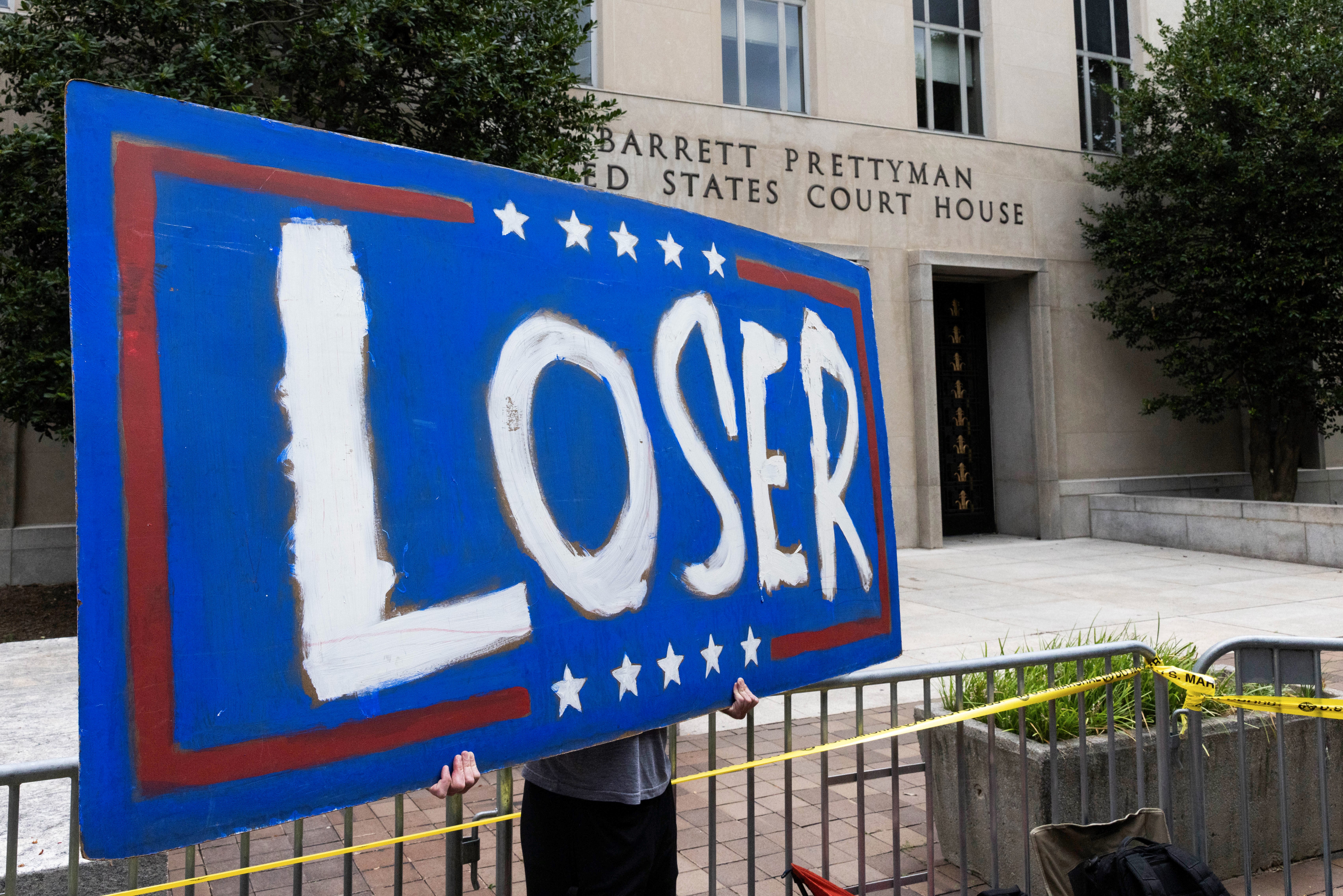 A protester stands with a sign outside E. Barrett Prettyman United States Court House, in Washington D.C., the United States, Aug. 3, 2023. (Aaron Schwartz/Xinhua via Getty Images)