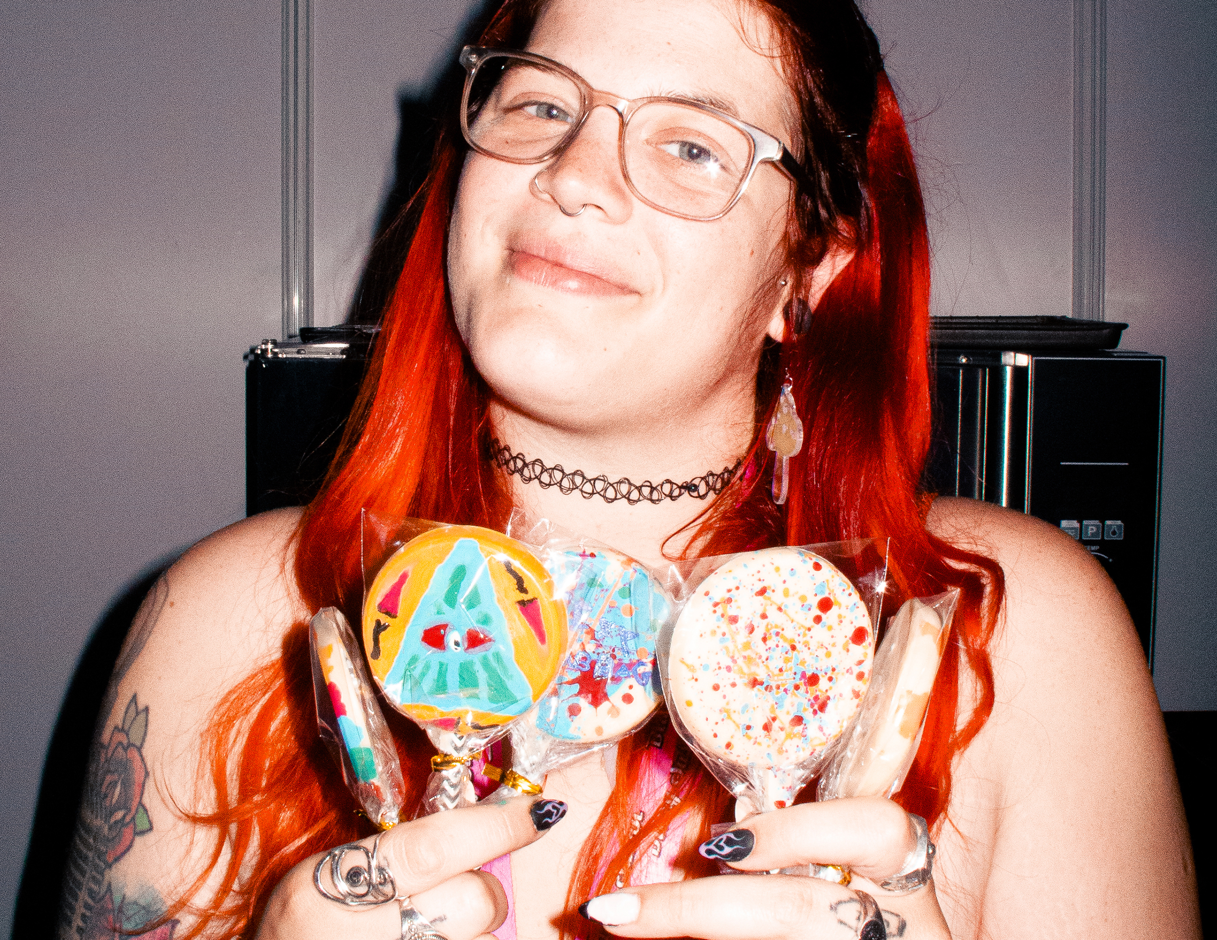Corey holding her chocolate lollipops at Product Earth UK cannabis event.
