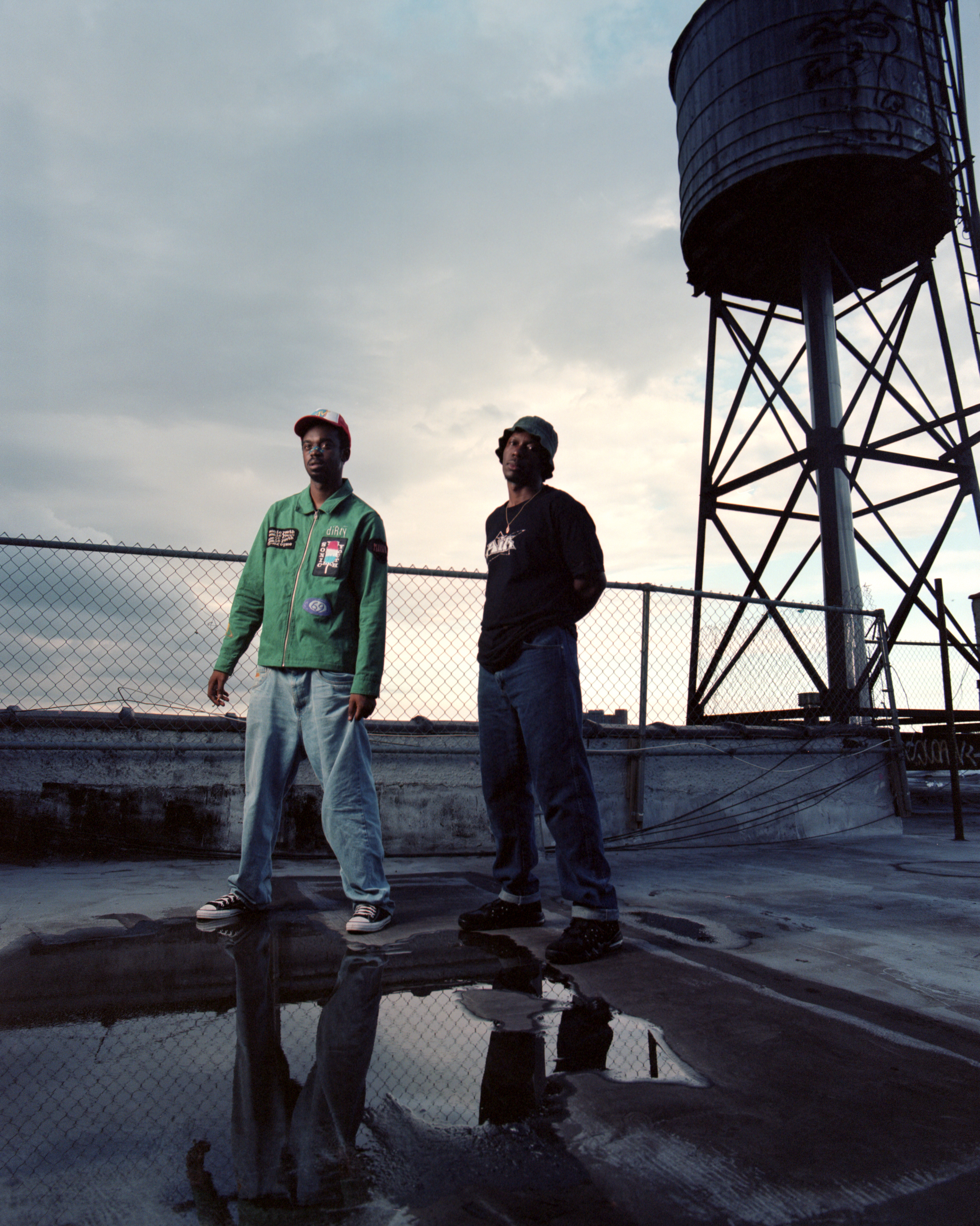 the rap duo paris texas posing for a portrait on a roof