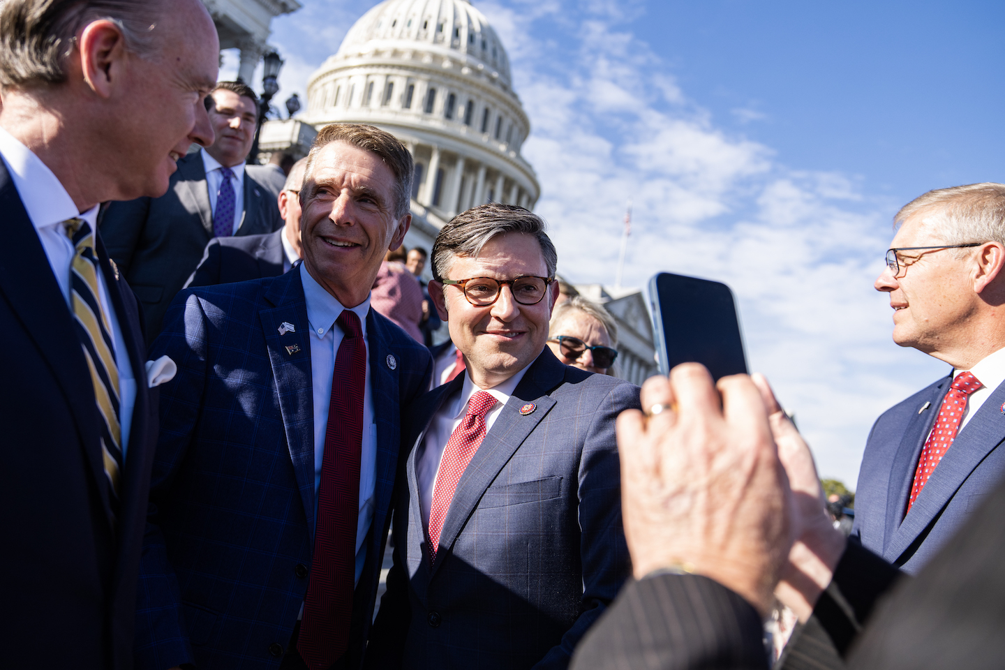 Speaker of the House Mike Johnson, R-La., second from right, takes pictures with members after a news conference on the House steps of the the U.S. Capitol after winning the speakership on Wednesday, October 25, 2023. (Tom Williams/CQ-Roll Call, Inc via Getty Images)