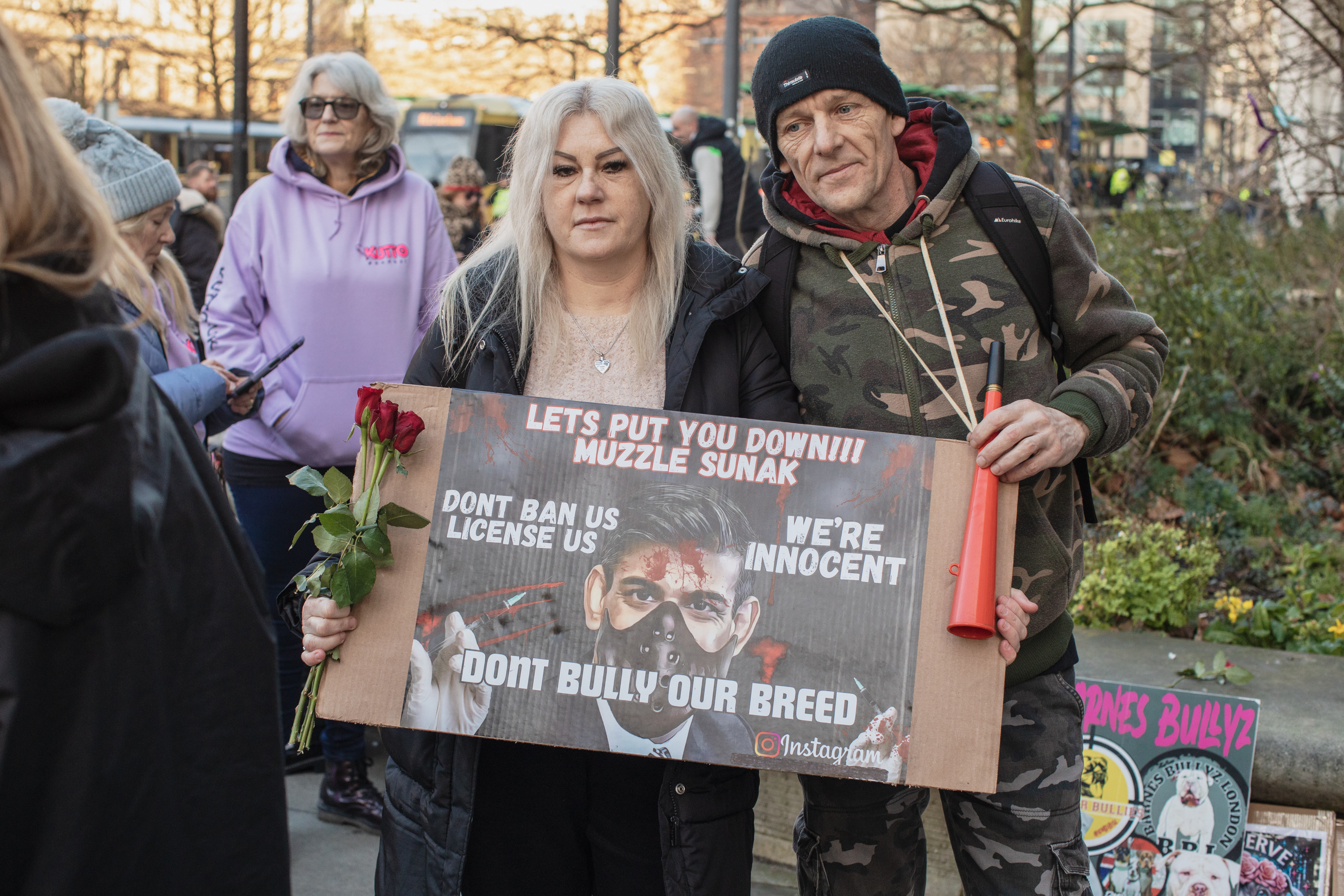 Manchester, UK: Two protesters holding up a sign reading 