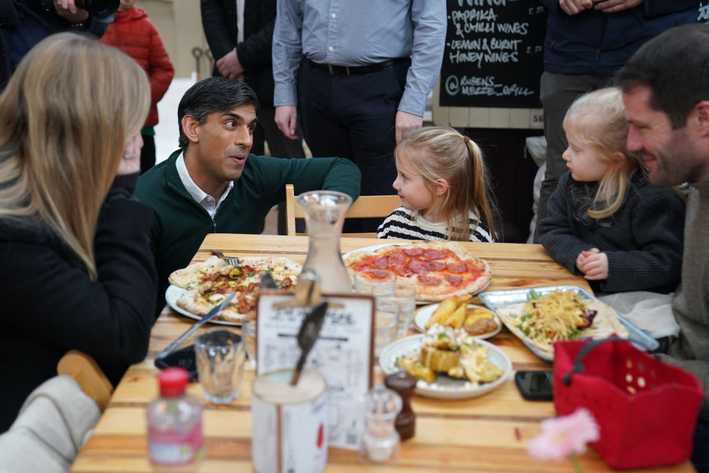 Rishi Sunak, not looking at the pizza