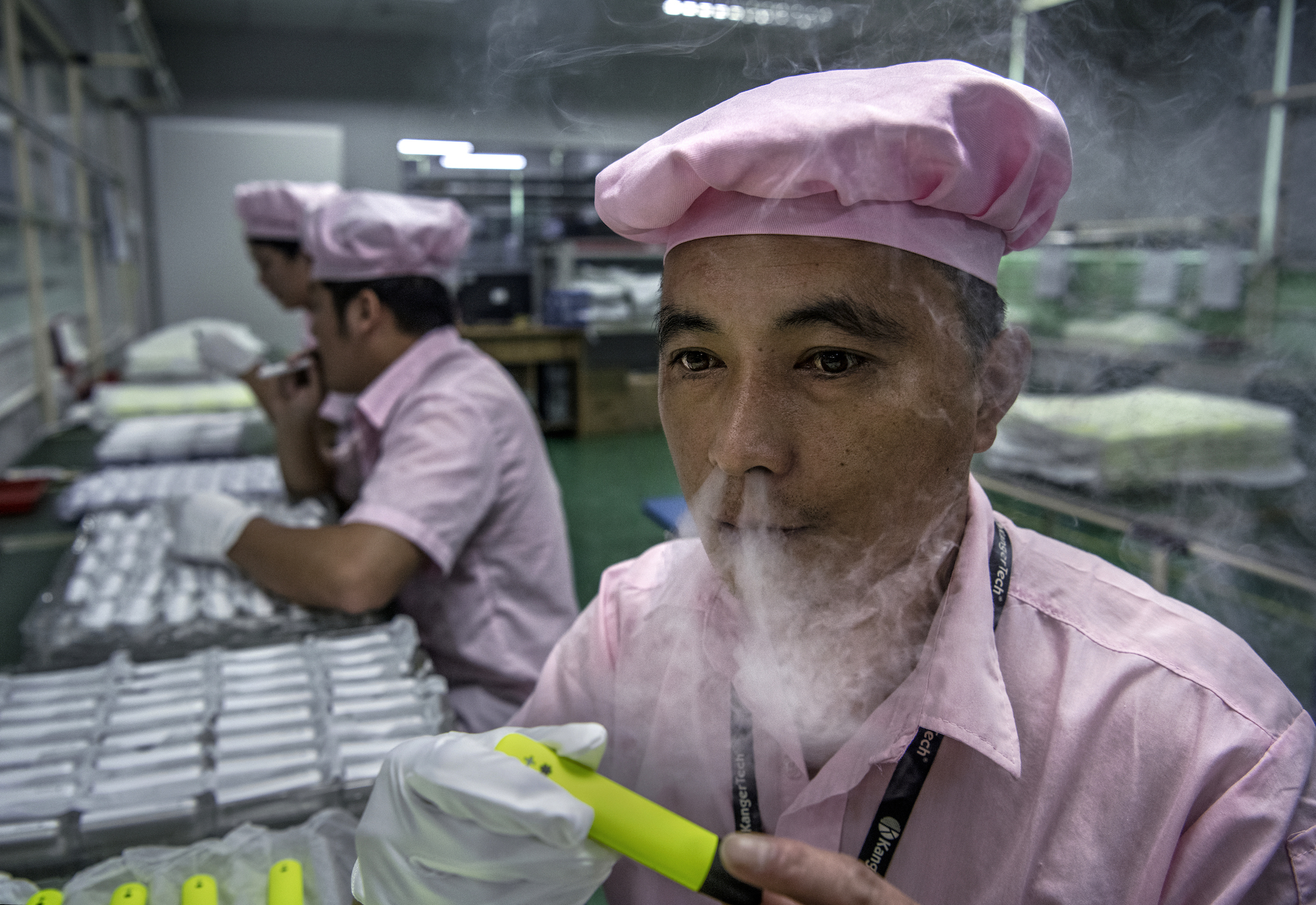 A worker in Vape Valley, Shenzhen tries out a product