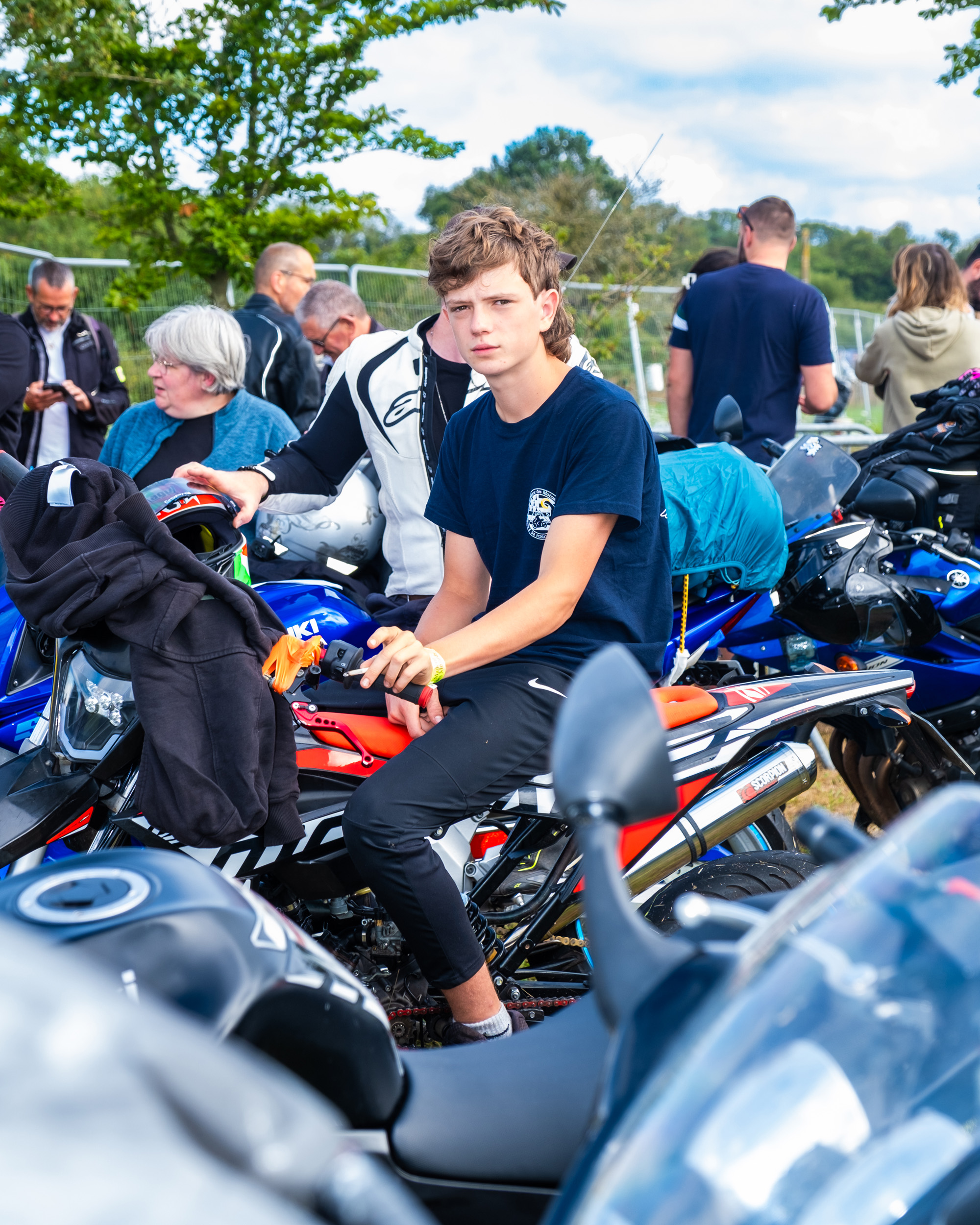 priest bless motorcycle rider at Le Pardon des Motards pilgrimage in porcaro brittany france