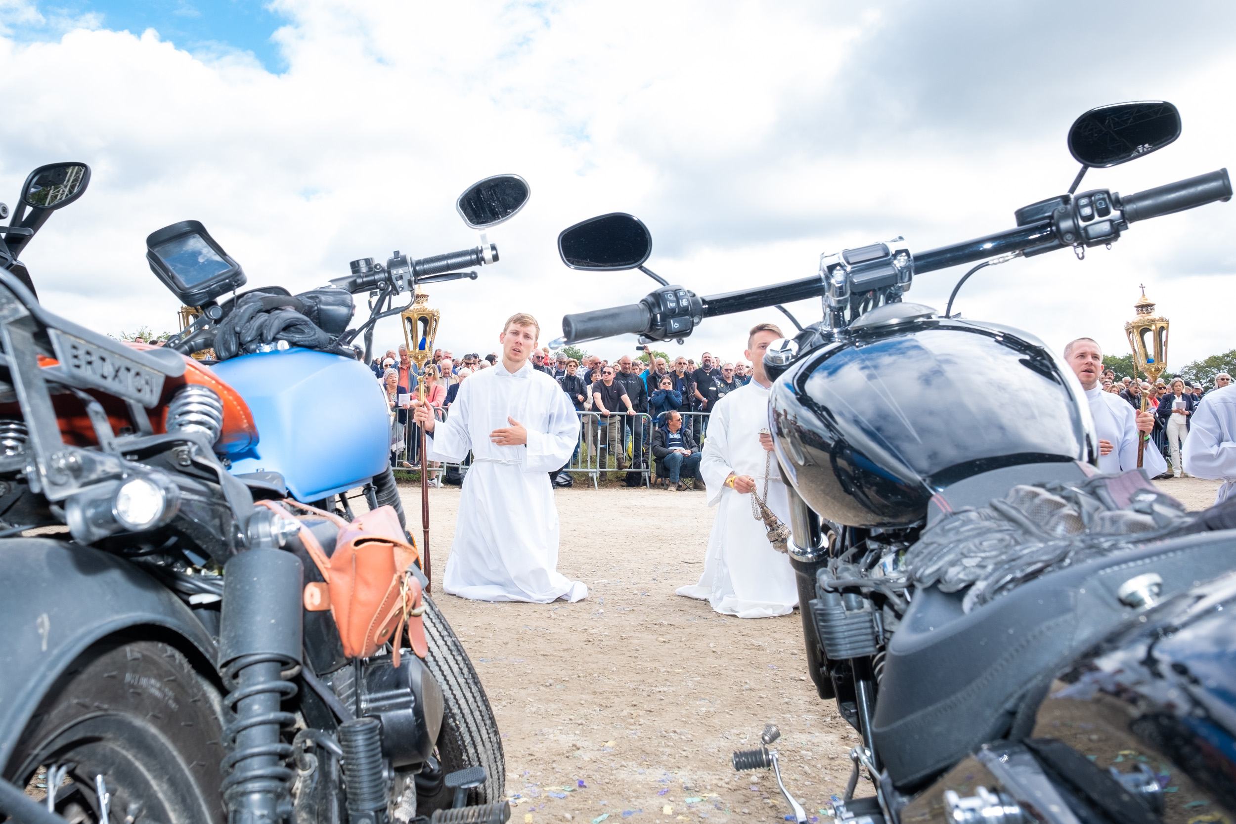 priest bless motorcycle rider at Le Pardon des Motards pilgrimage in porcaro brittany france