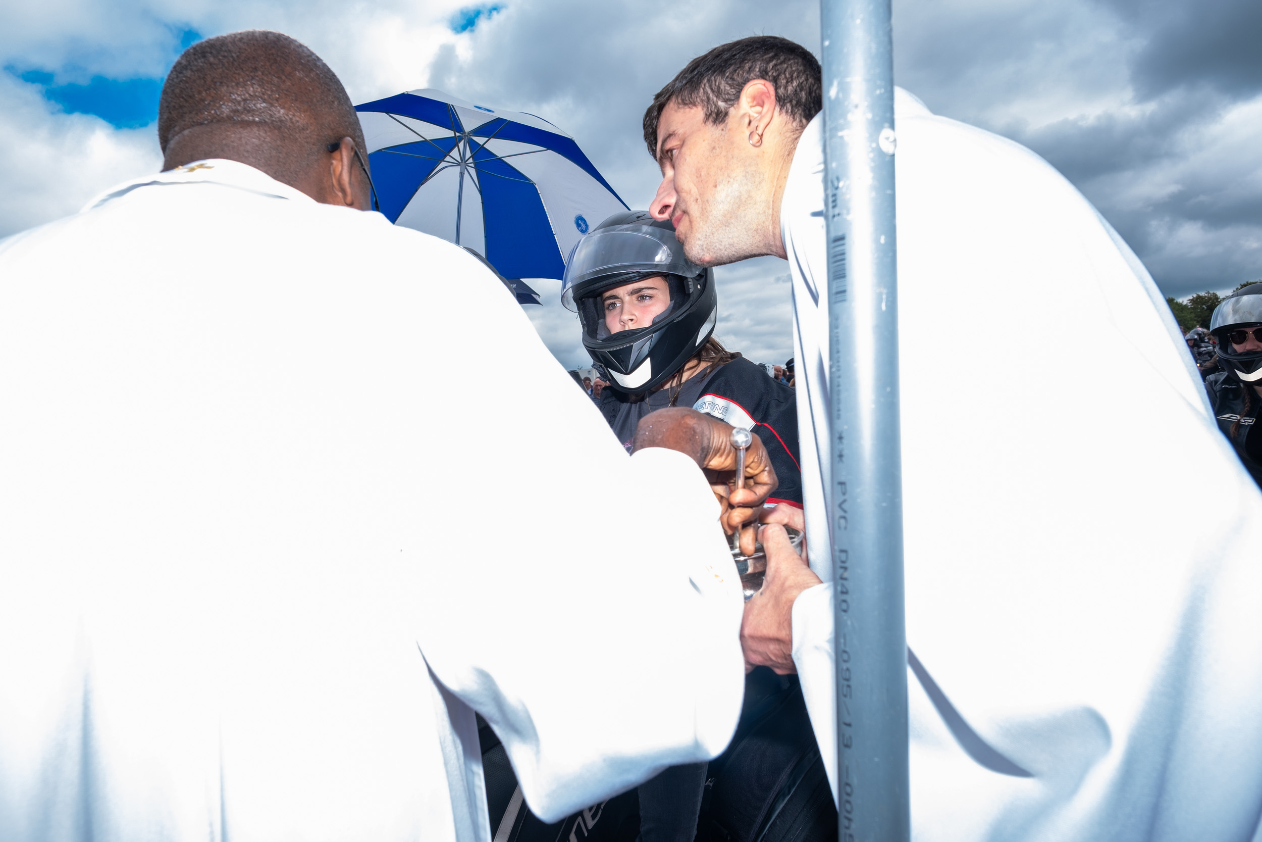 priest bless motorcycle rider at Le Pardon des Motards pilgrimage in porcaro brittany france