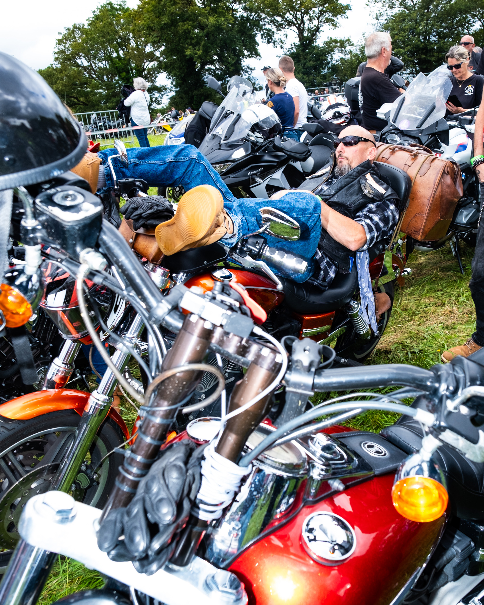 priest bless motorcycle rider at Le Pardon des Motards pilgrimage in porcaro brittany france