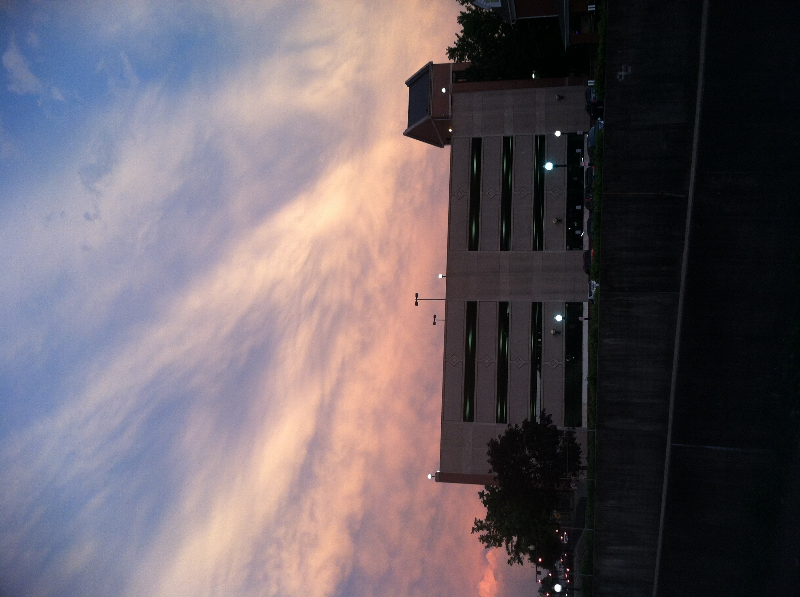 A picture of a large multi storey building at sunset.