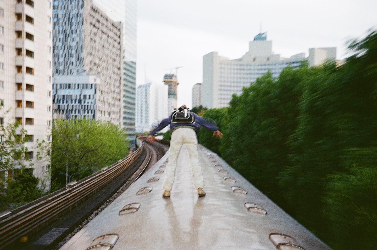 Man surfing on top of train in Europe.