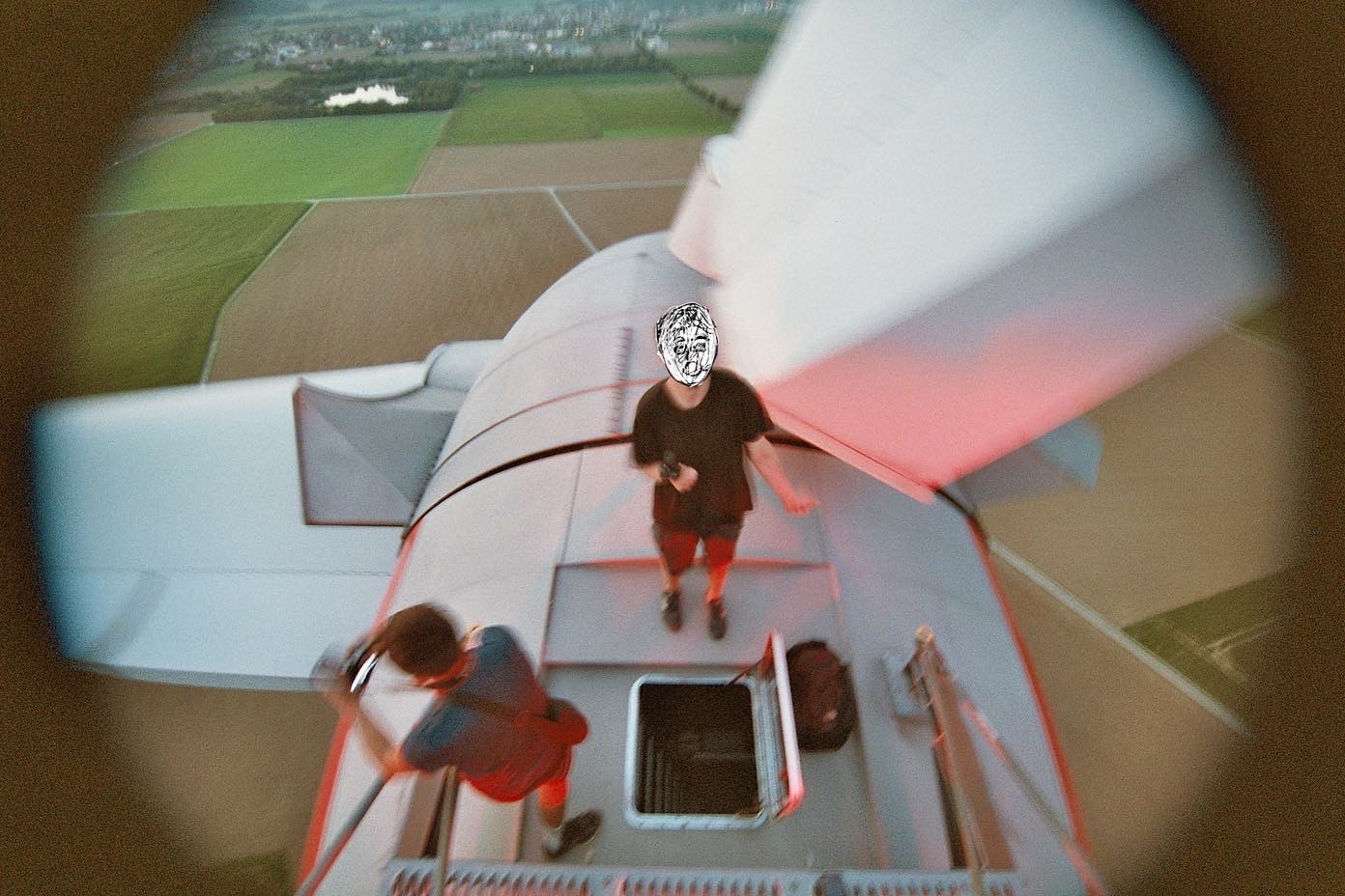 Two men on top of wind turbine in Europe.