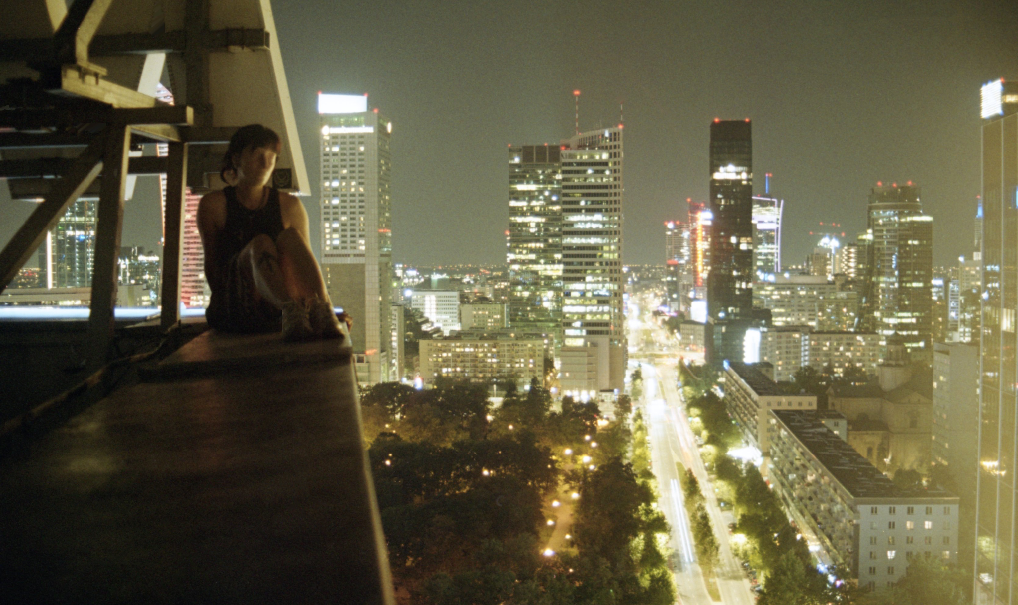 Woman on ledge of building in Europe.