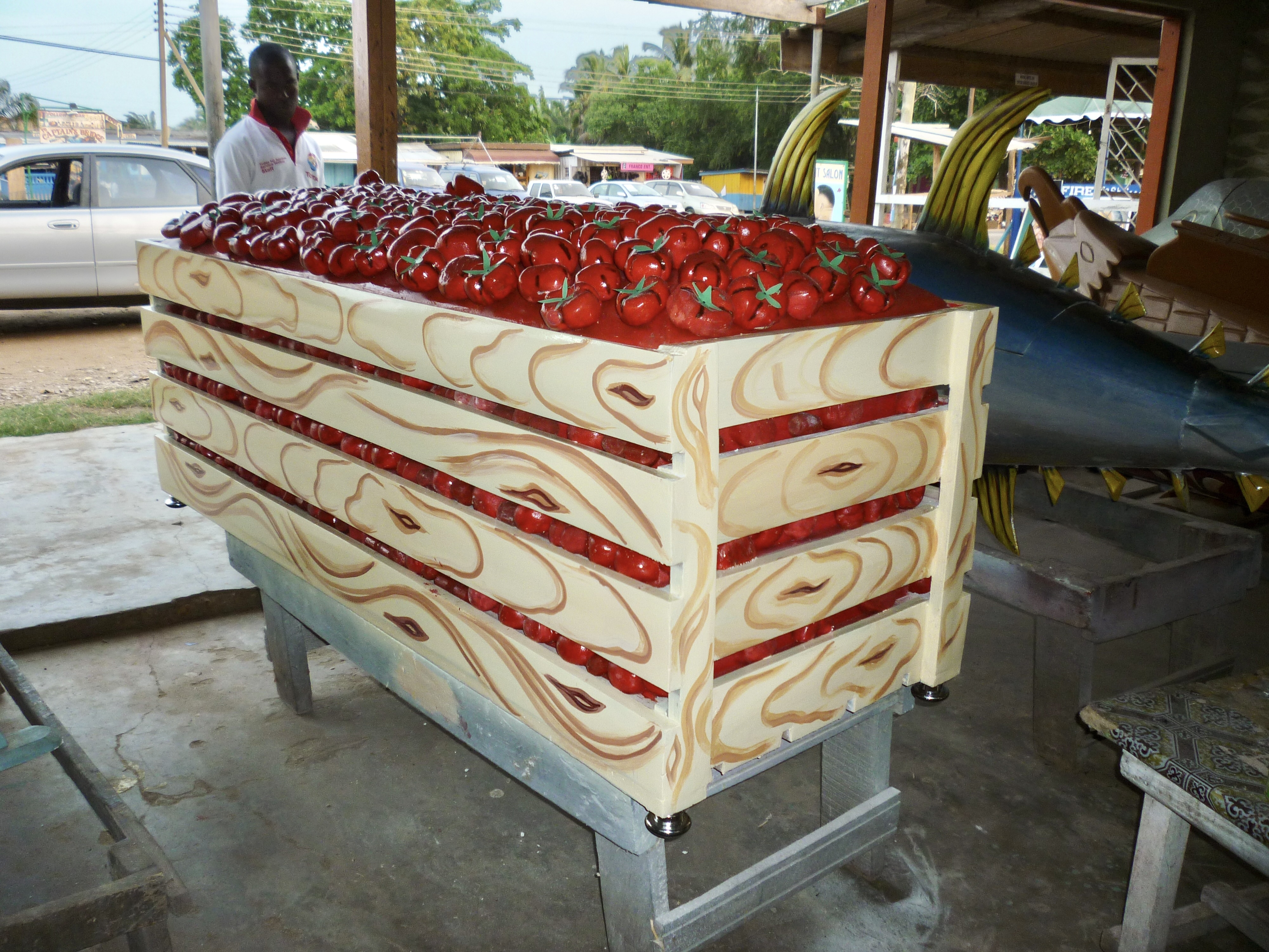 A coffin in the shape of a crate of tomatoes.