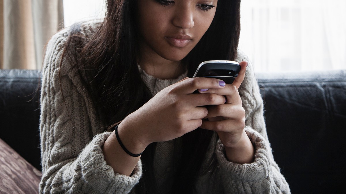 Those phones. Black girl Focus on smartphone.