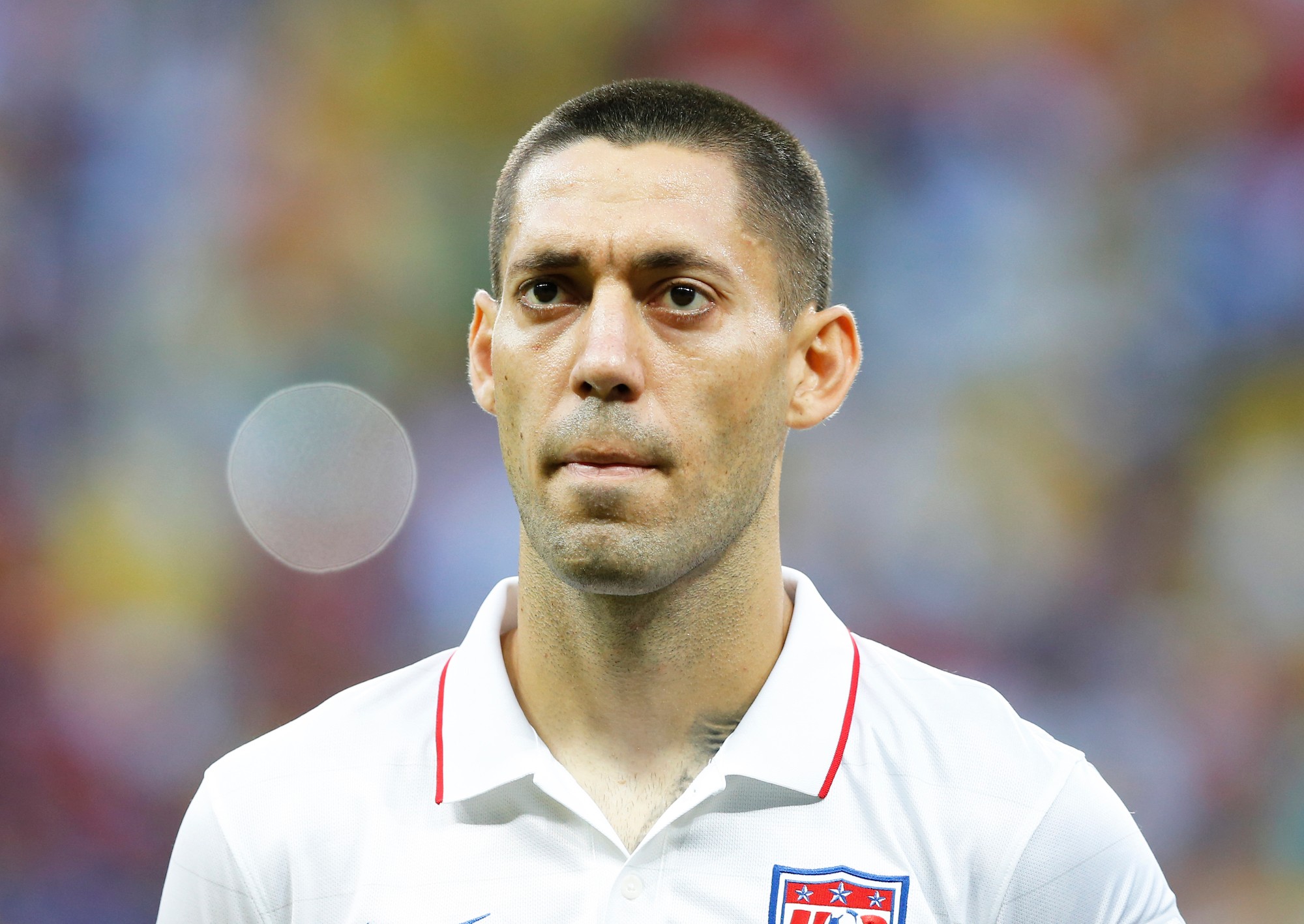 U.S. soccer star Clint Dempsey drives fast, with a fistful of