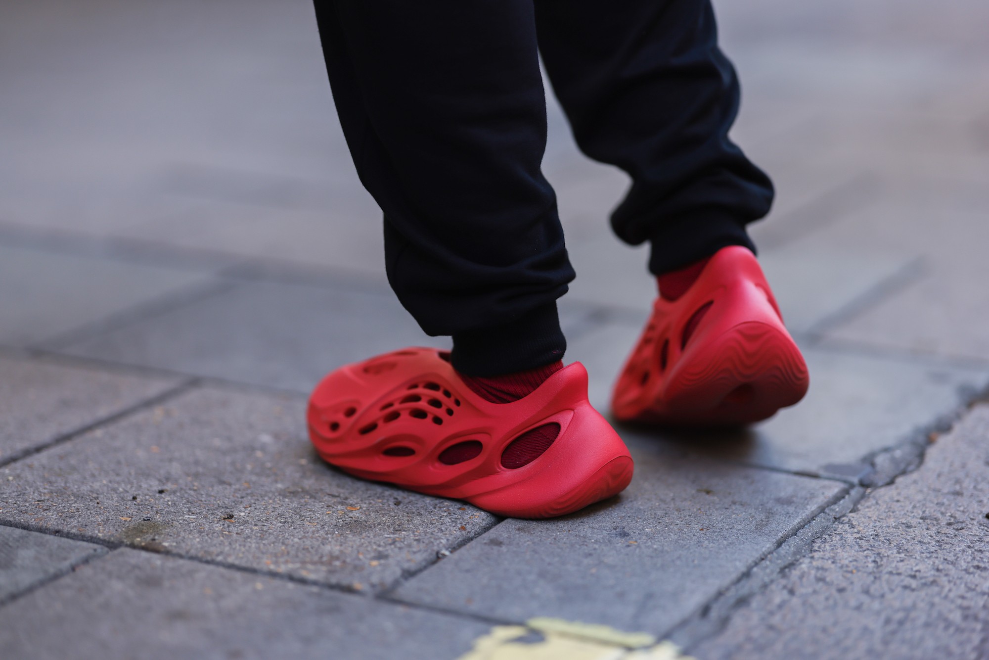 Kanye West wears red Louis Vuitton shoes that he designed at the News  Photo - Getty Images