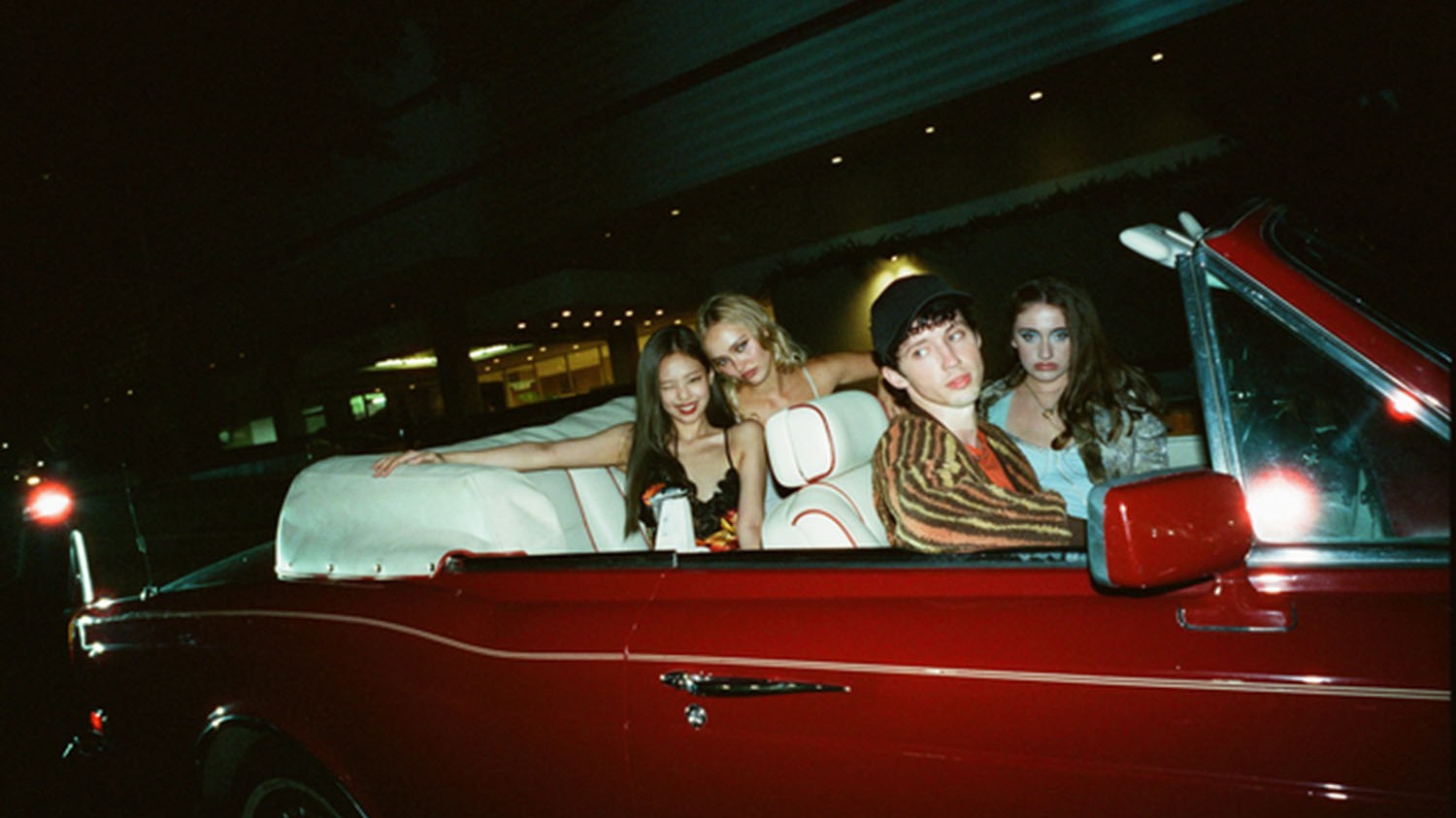 jennie kim, troye sivan, lily rose depp and rachel sennott pose in a red convertible while filming hbo's the idol