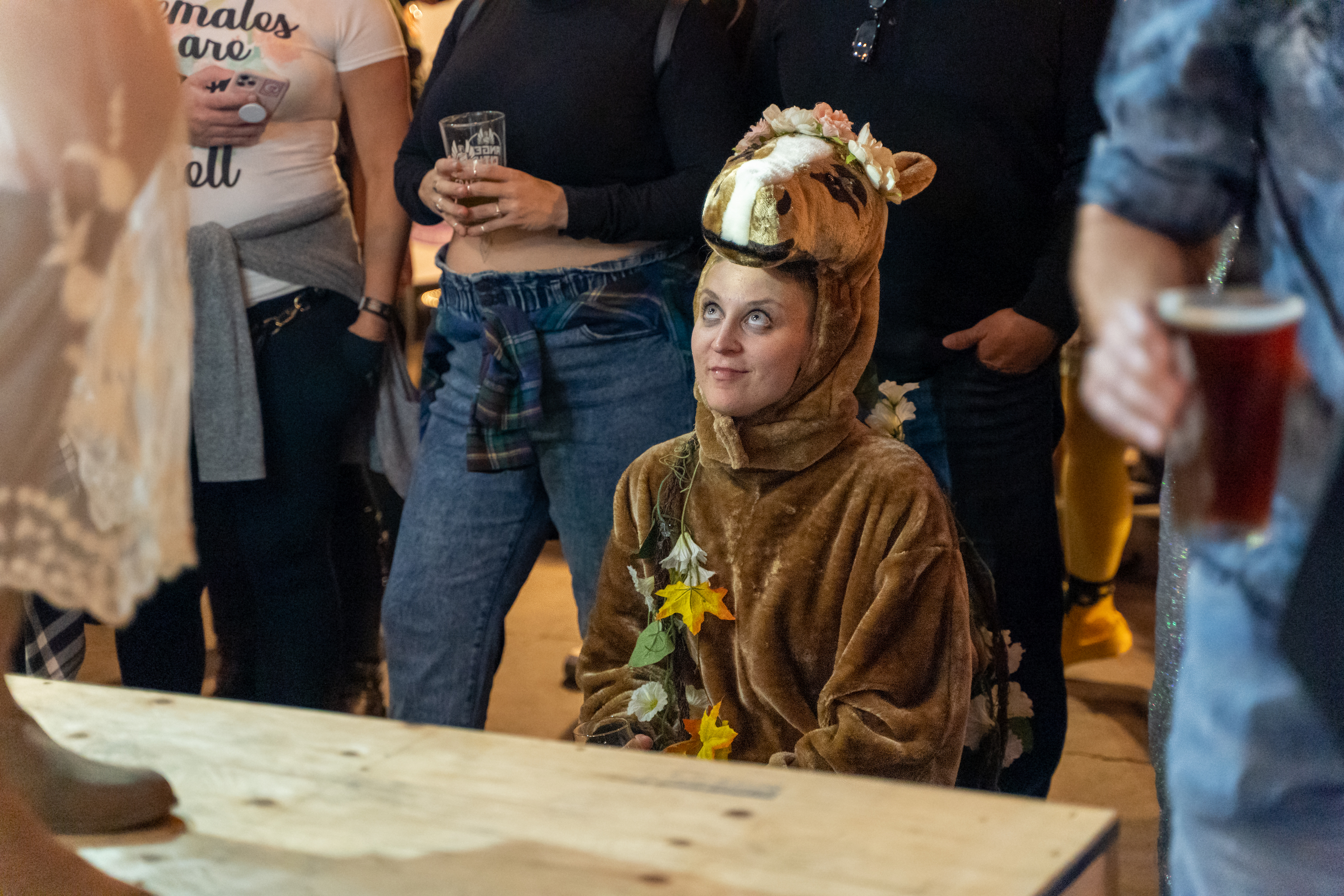 woman watching an event in a horse costume 