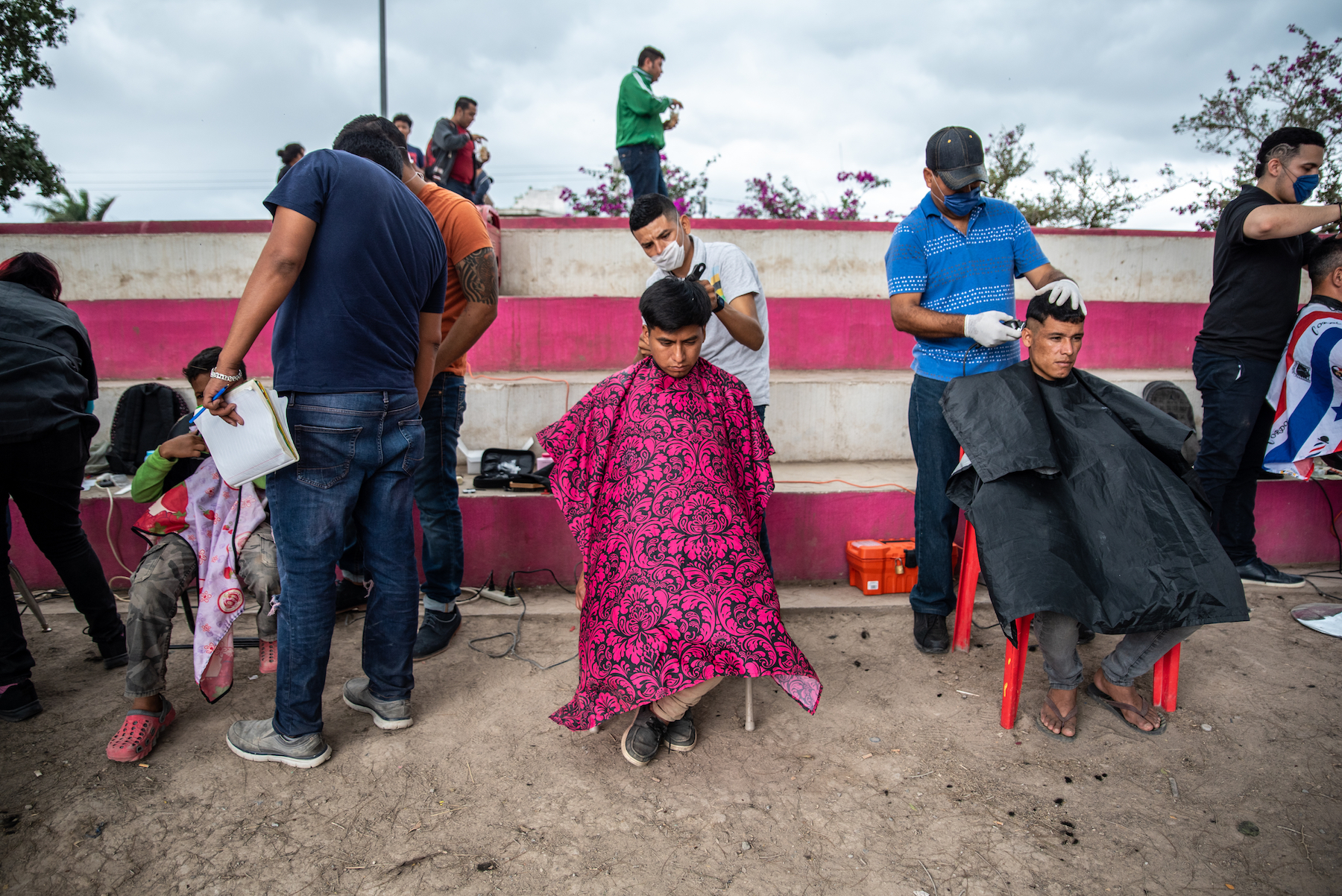 A group of barber shop students offer free haircuts to migrants staying at the camp in Matamoros.