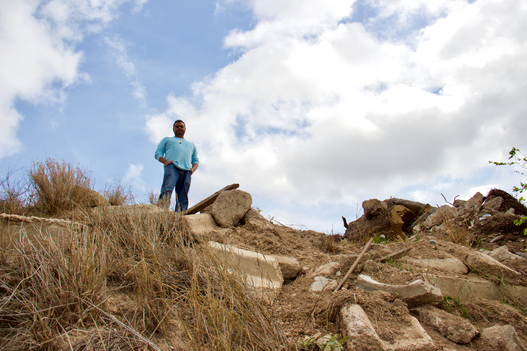 Isidro Leal overlooking the Rio Grande before a US Customs and Border Patrol helicopter swoops across from the Mexican side of the river to circle overhead.