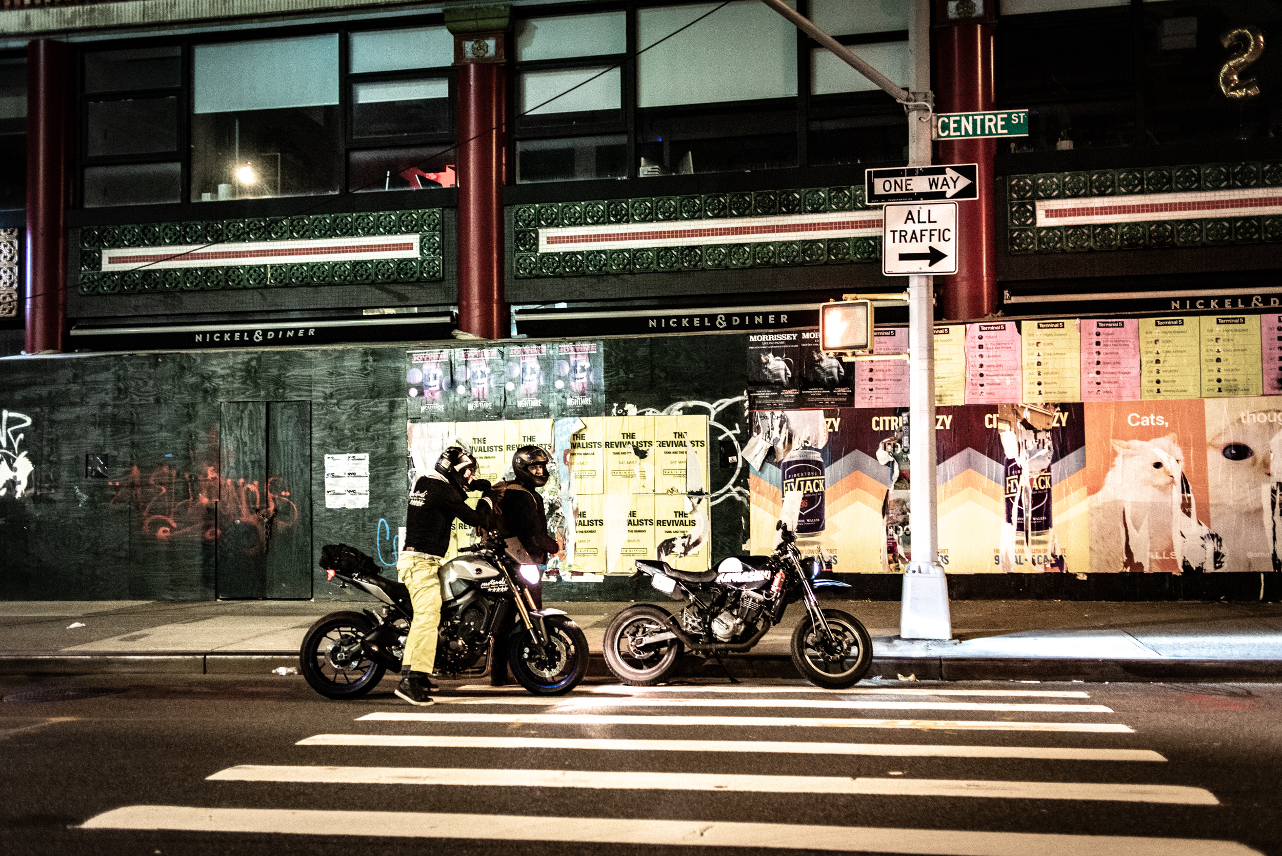 Two motorcyclists pulled over on Centre Street in Manhattan at night