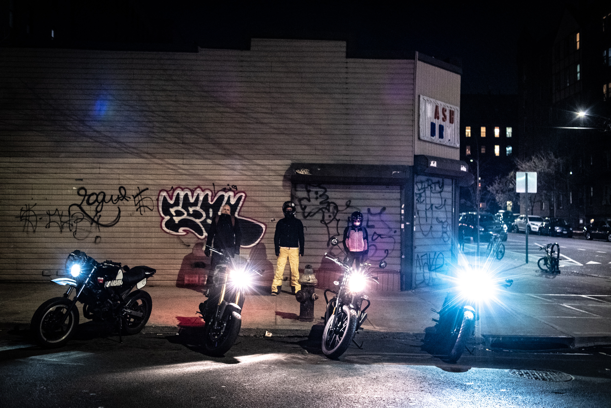 Motorcyclists lined up on a curb in Queens, New York