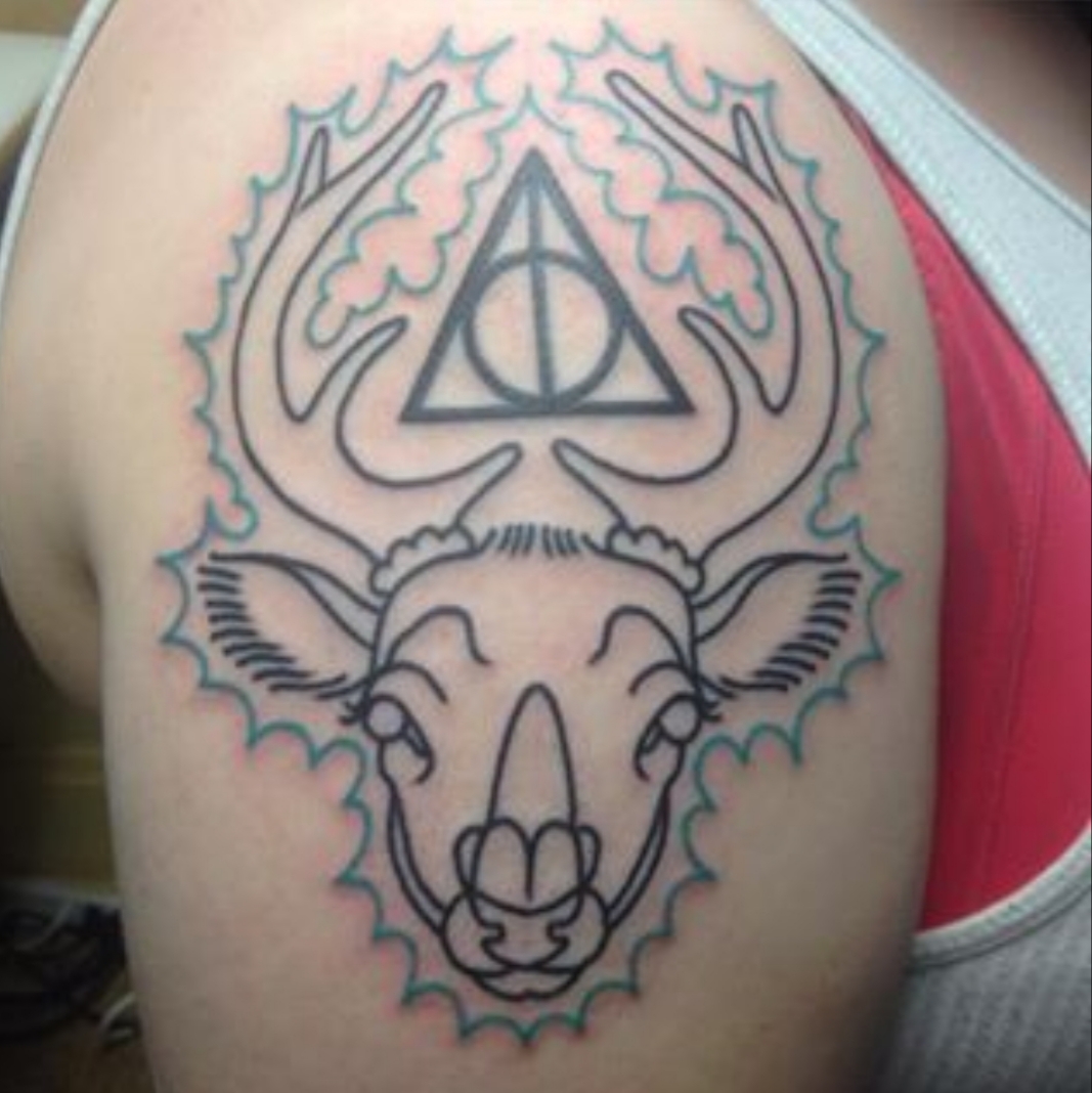 A Harry Potter tattoo depicting the deathly hallows and a stag.