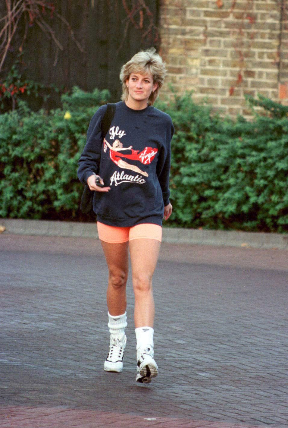Straight Diana in trainers, bike shorts and a virgin Atlantic jumper