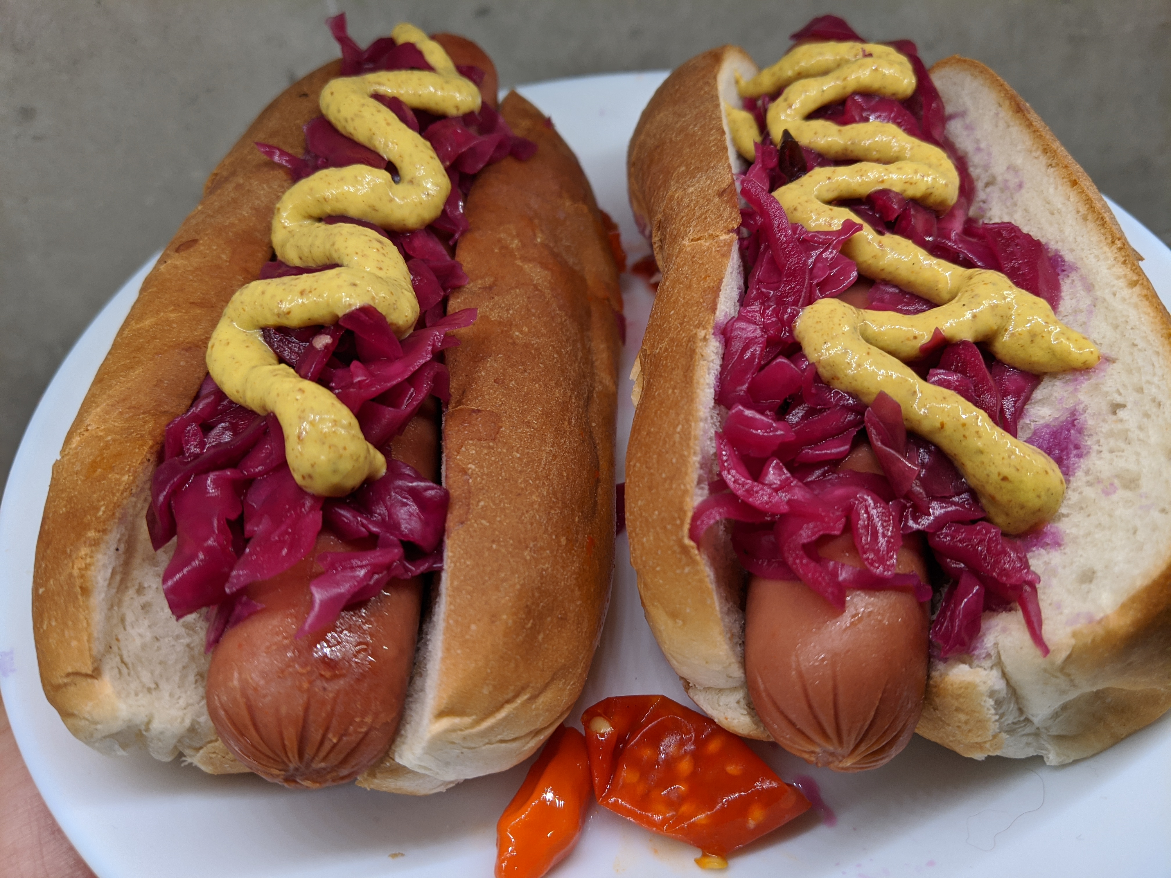 hot dogs with pickled cabbage and mustard